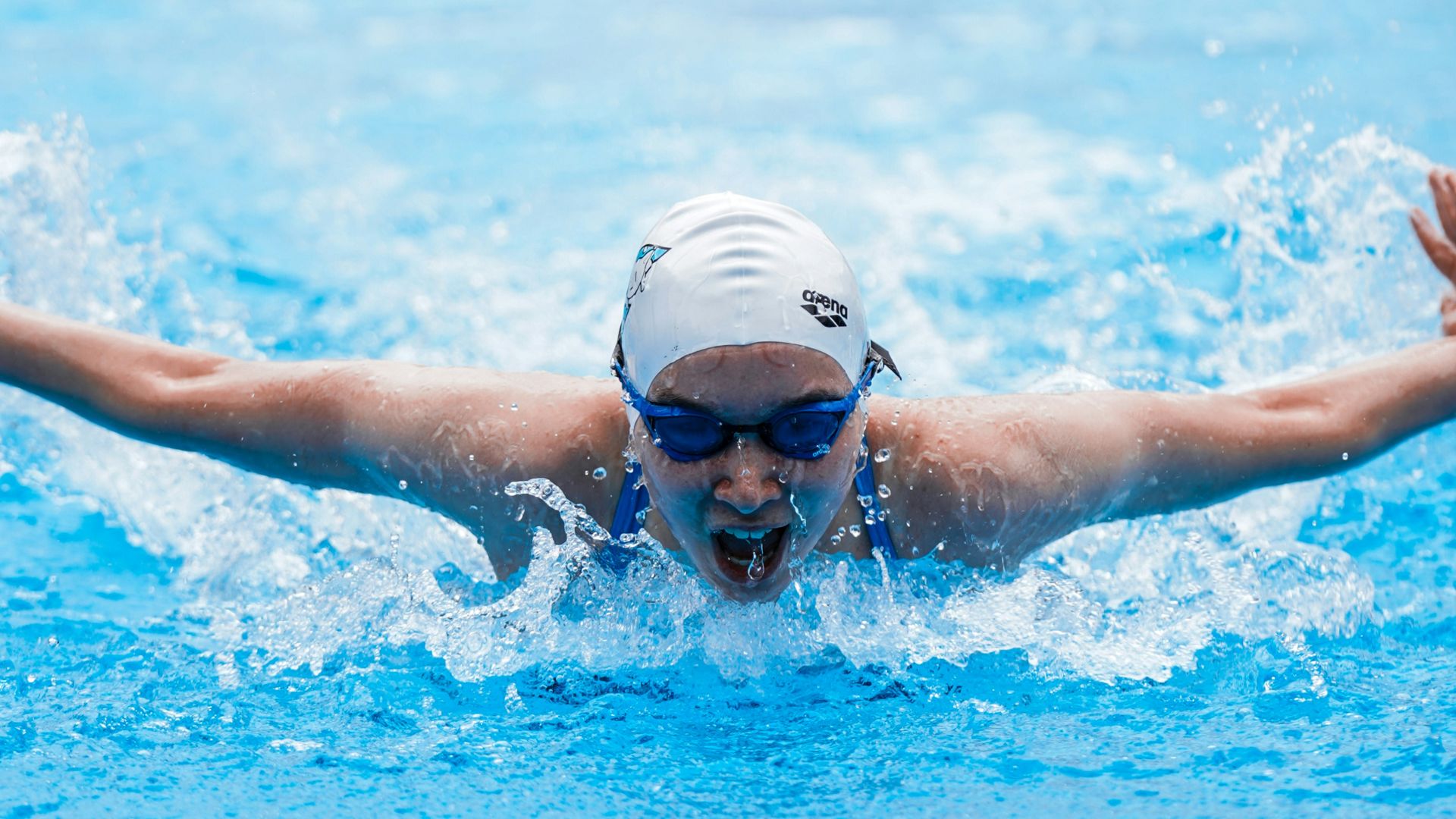 person in swimming goggles in water