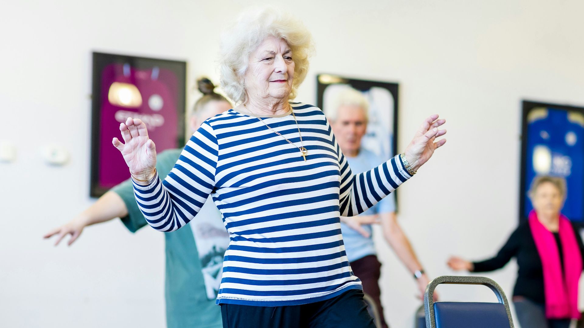 a group of older women dancing in a room