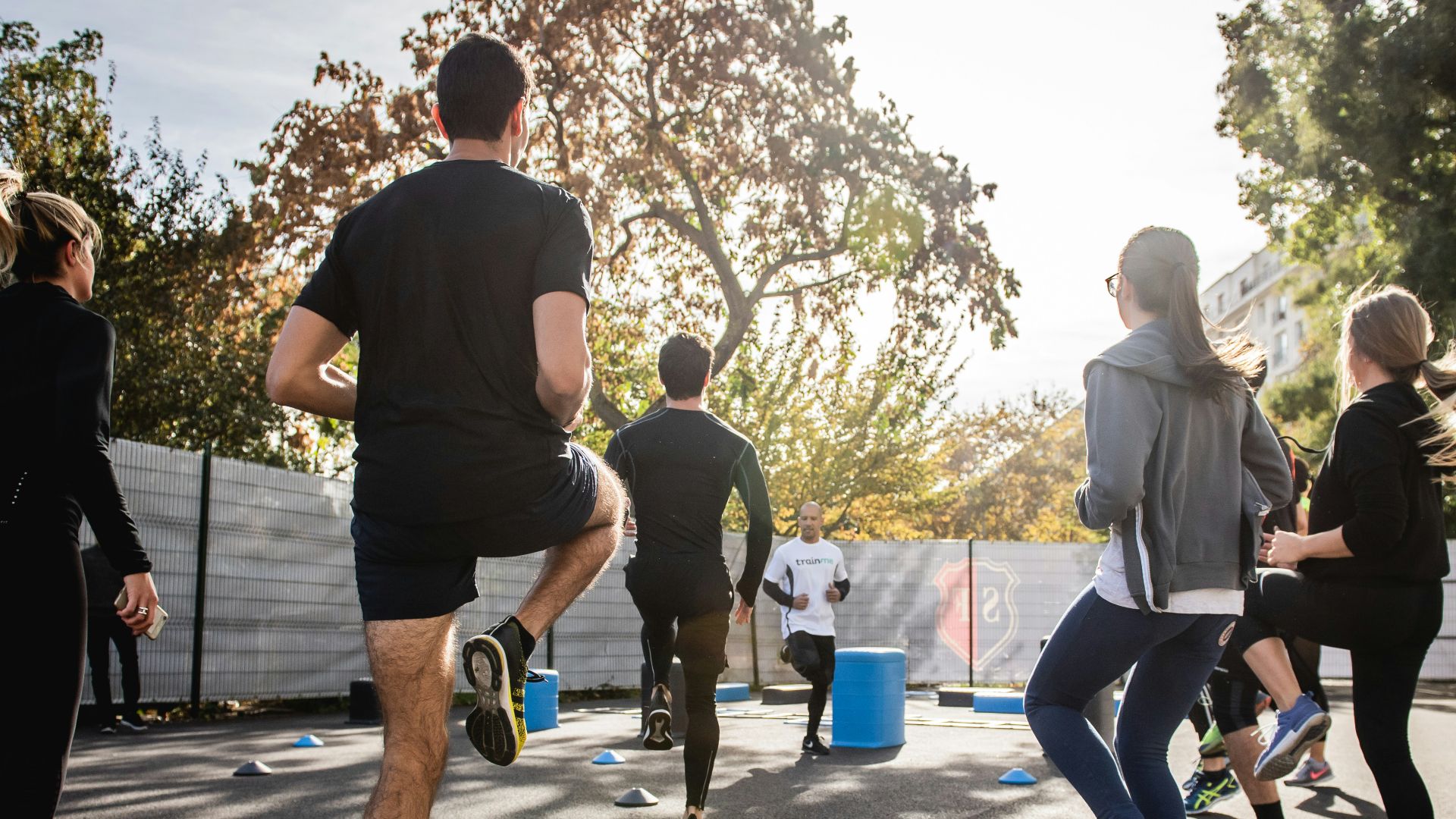 man in black t-shirt and black shorts running on road during daytime