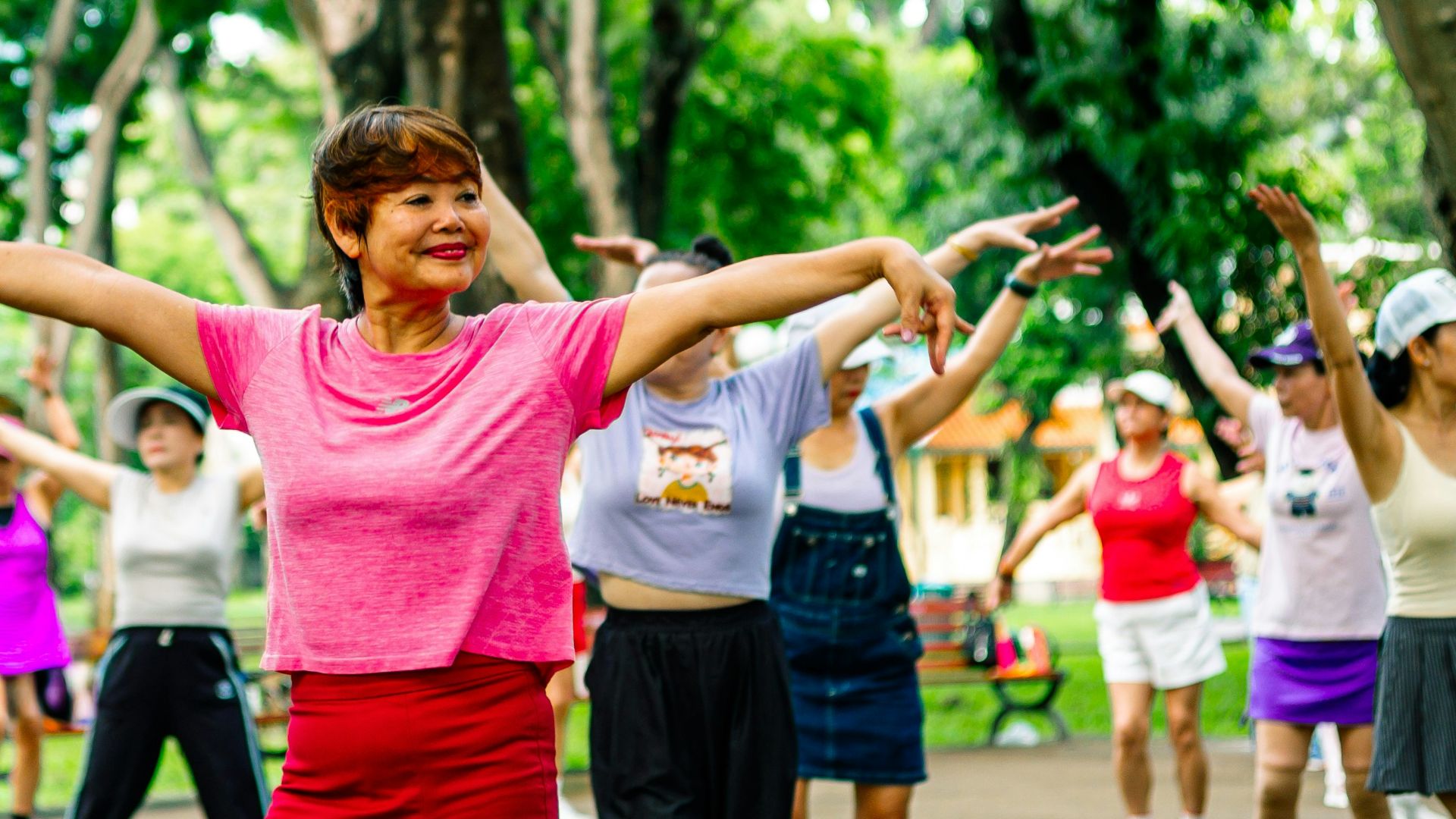 Group of women exercising together in a park.