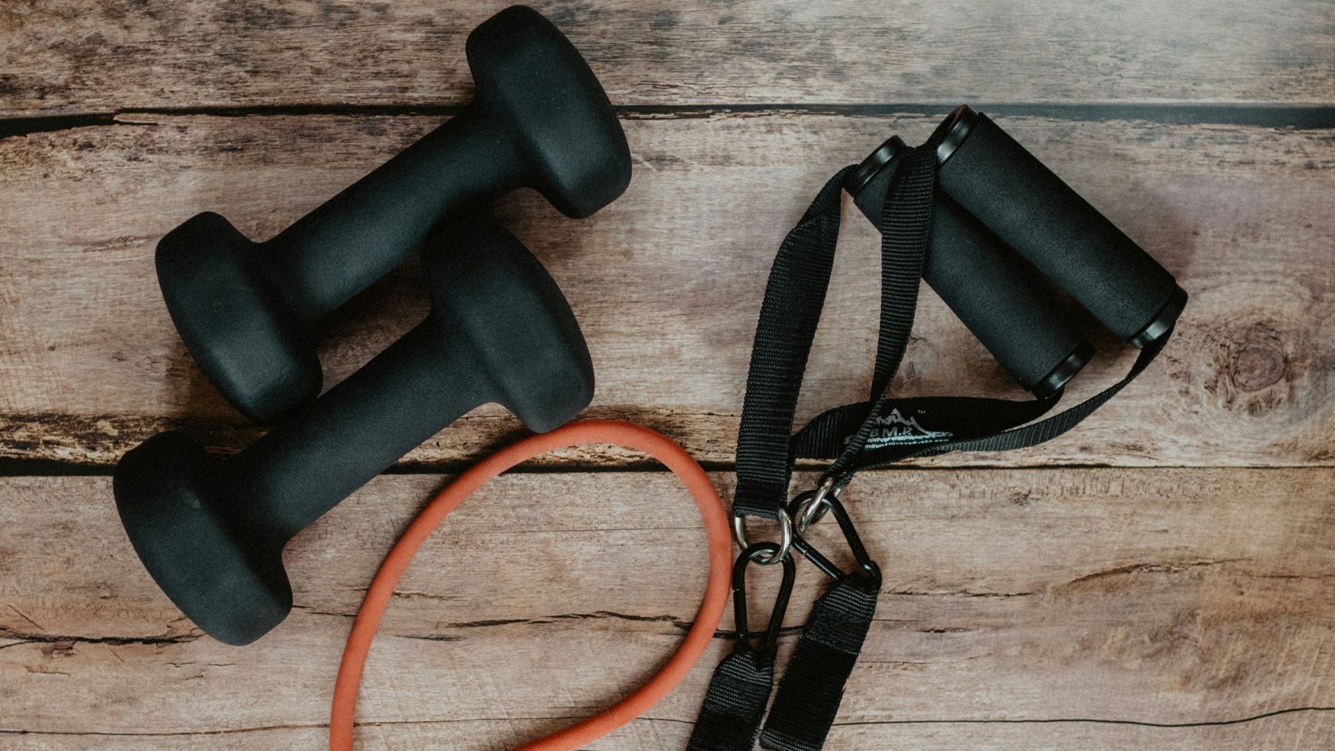 orange and black usb cable on brown wooden surface