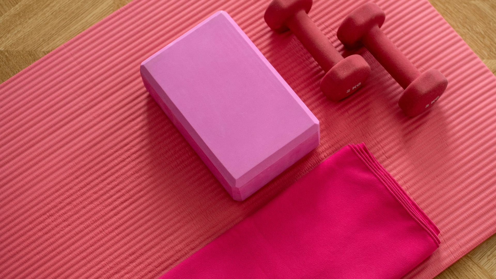 pink dumbbell on pink textile