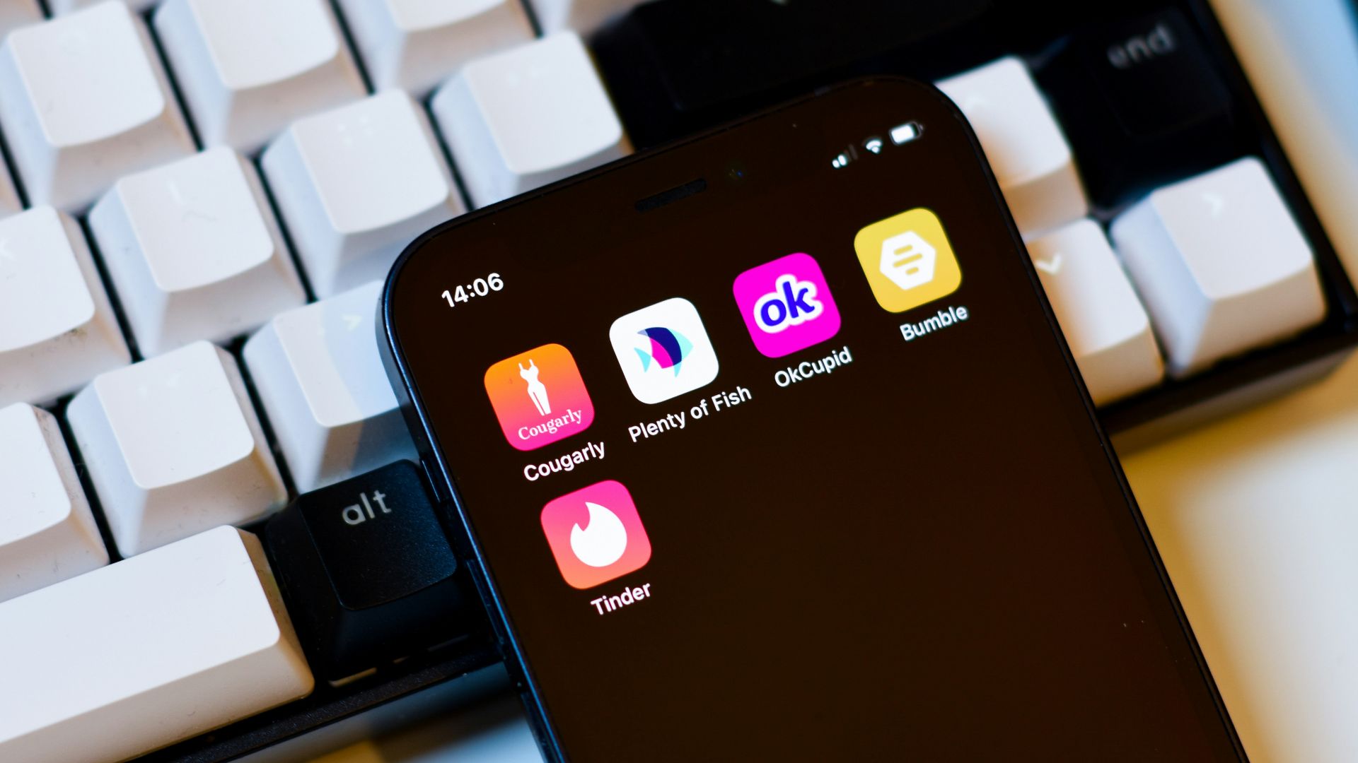 a cell phone sitting next to a keyboard