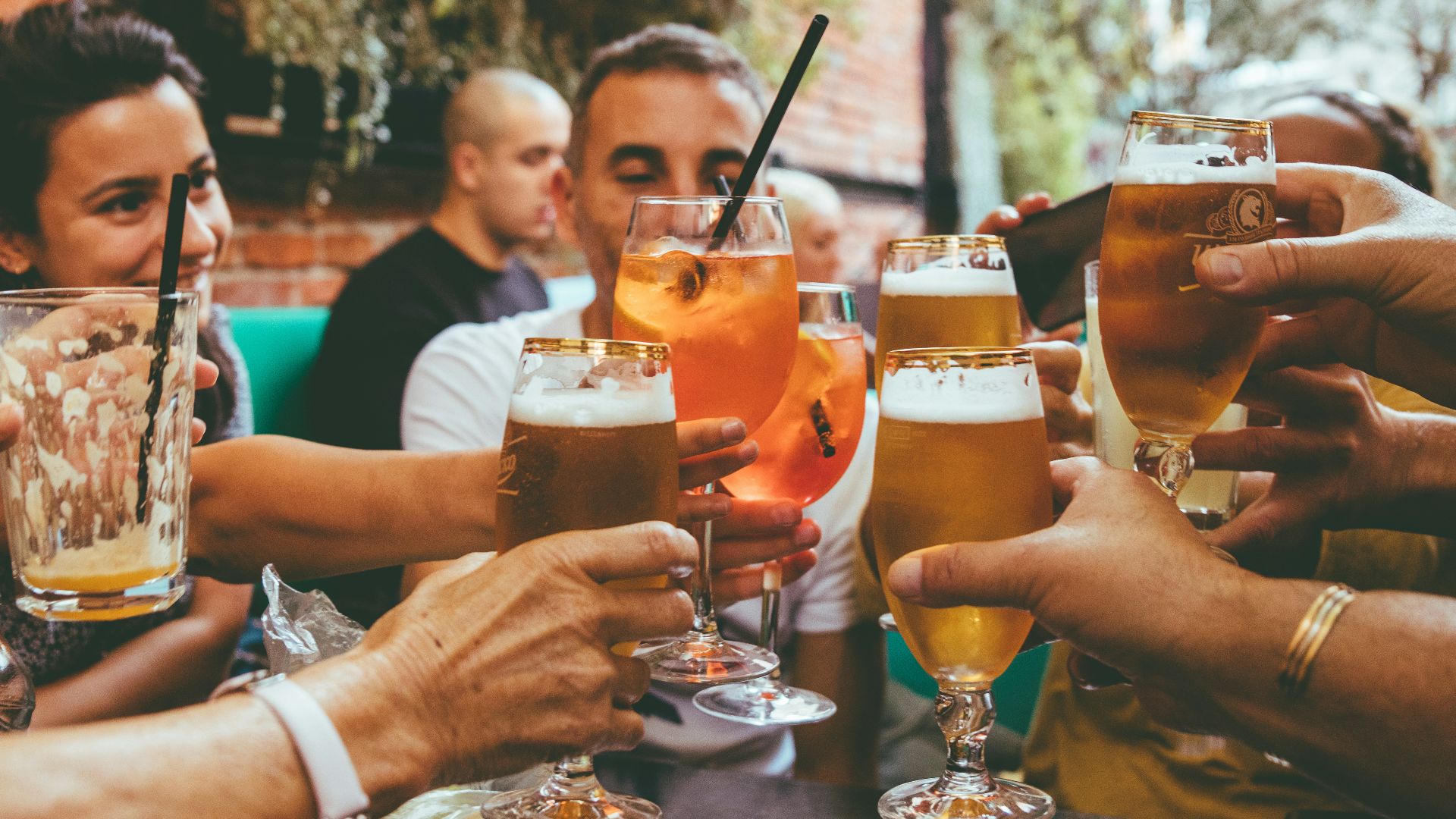 people holding drinks during day