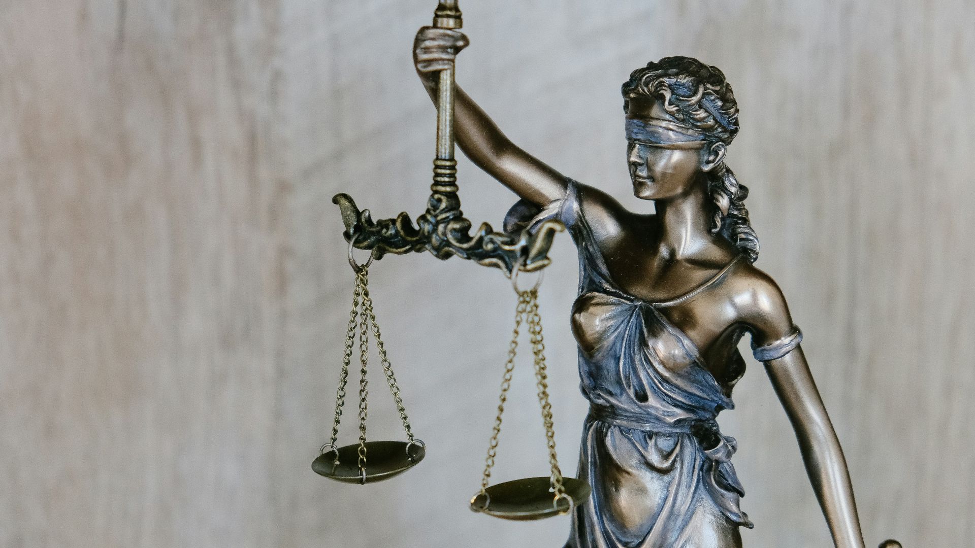 woman holding sword statue during daytime