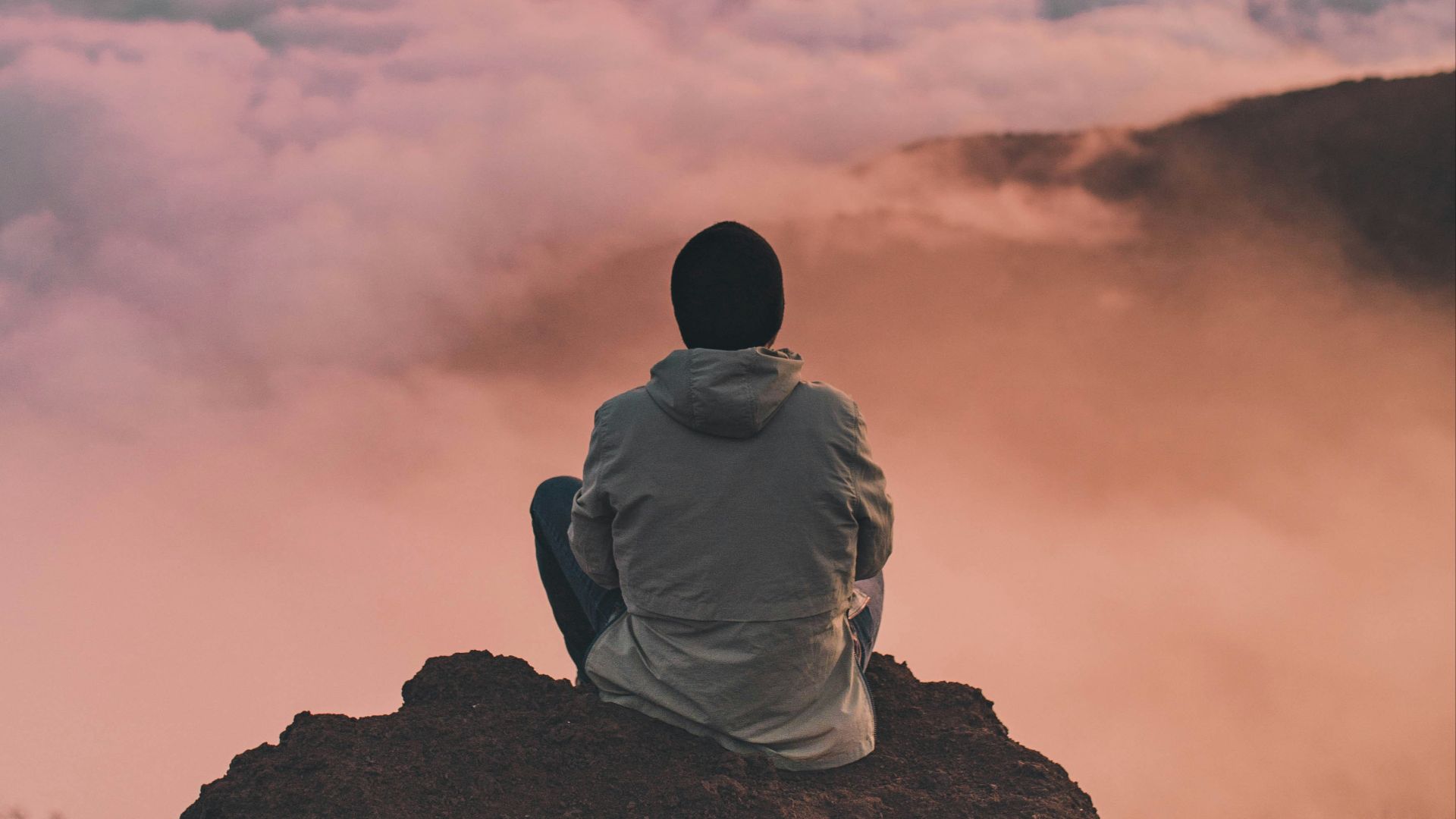 man sitting on cliff