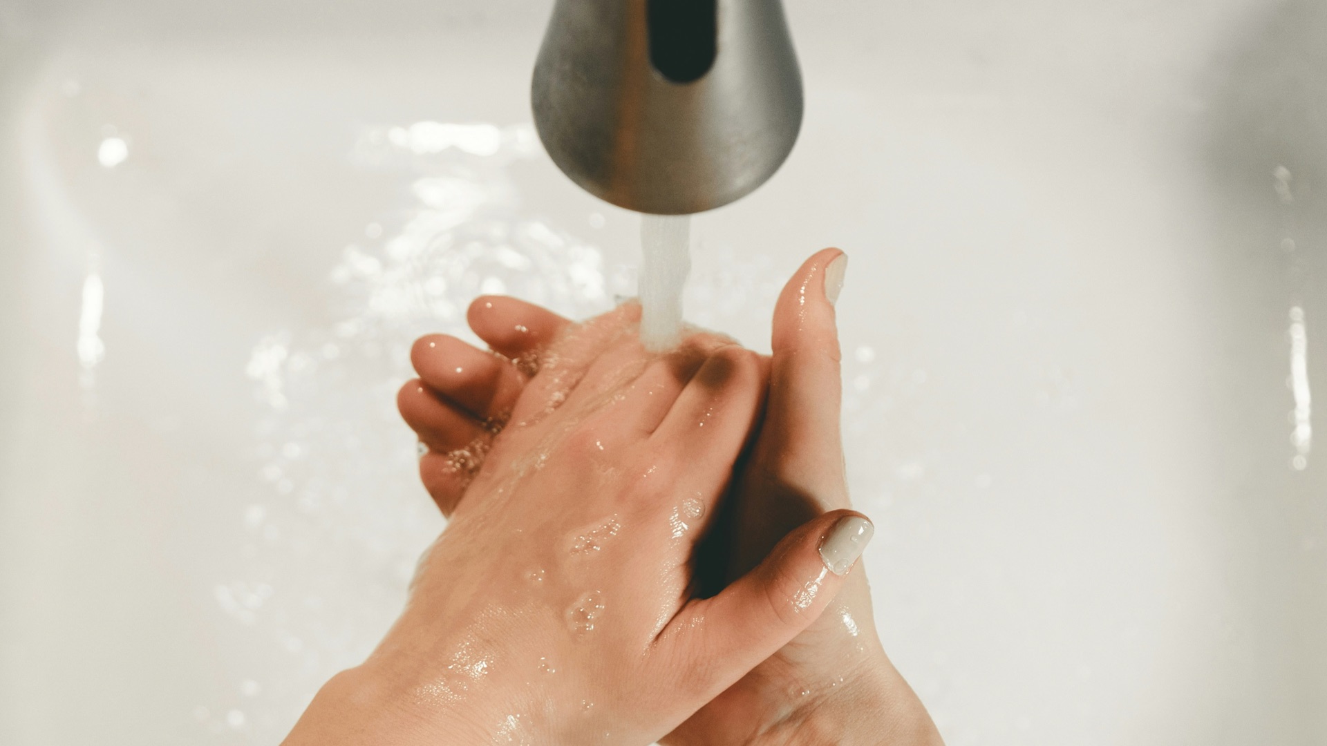 persons feet on white bathtub
