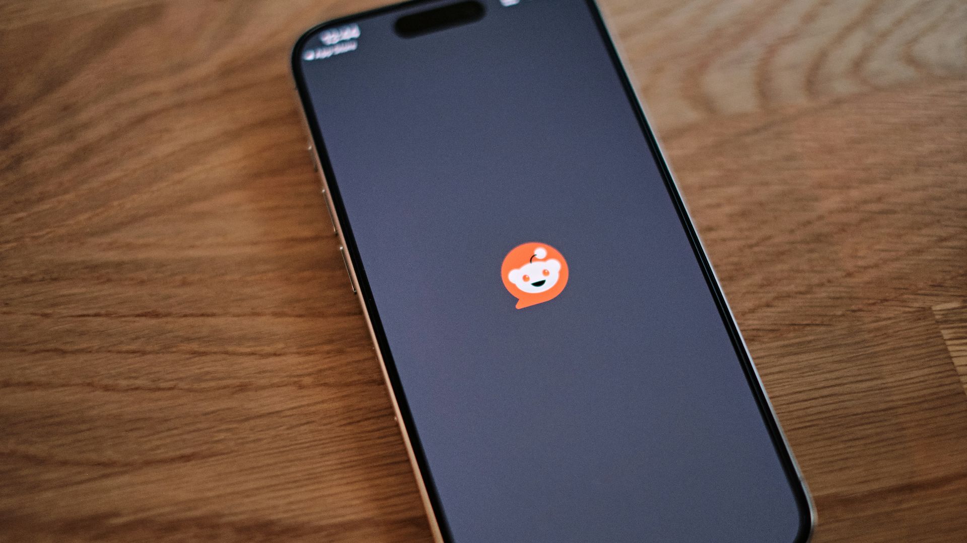 A cell phone sitting on top of a wooden table