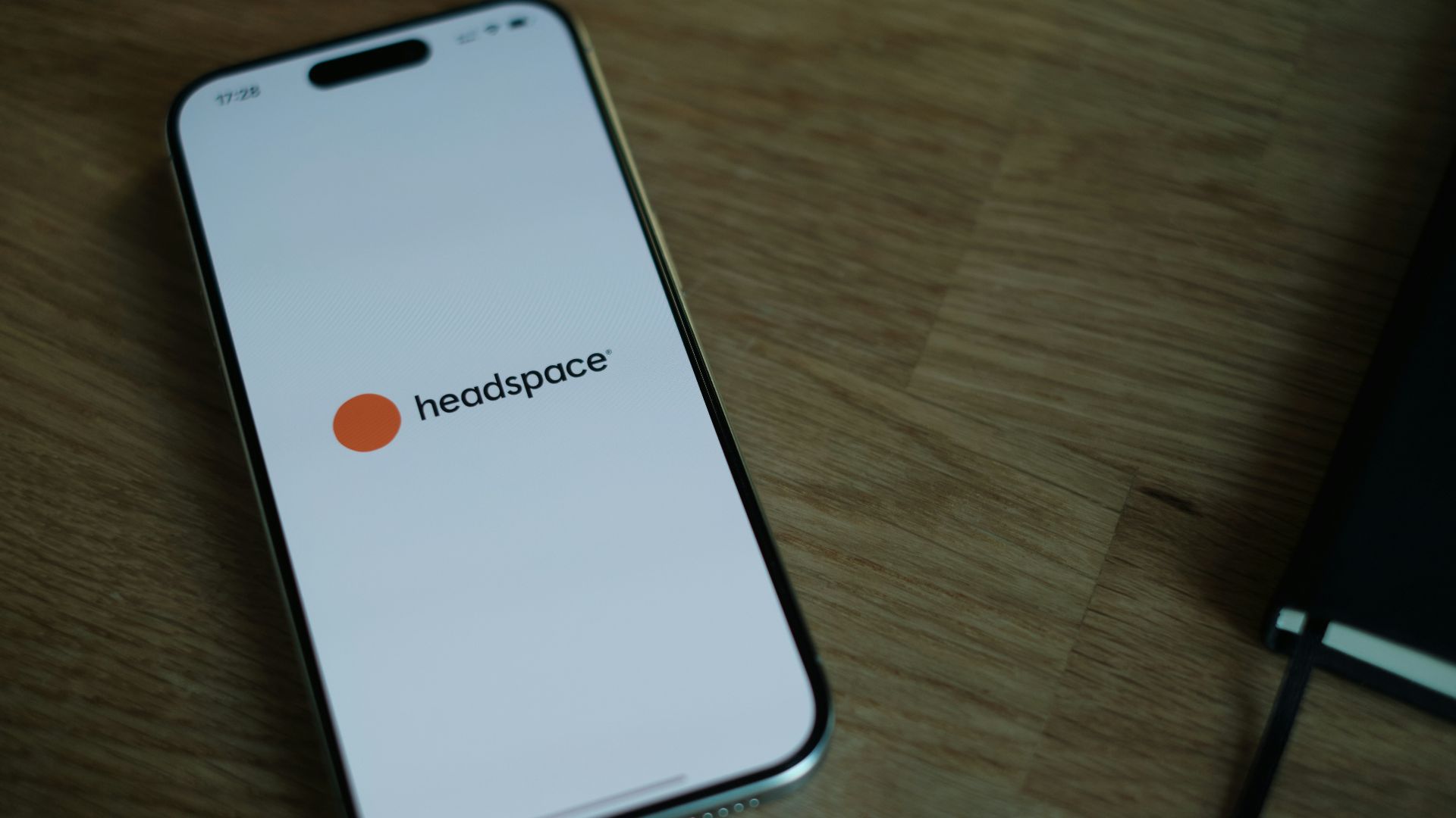 A cell phone sitting on top of a wooden table