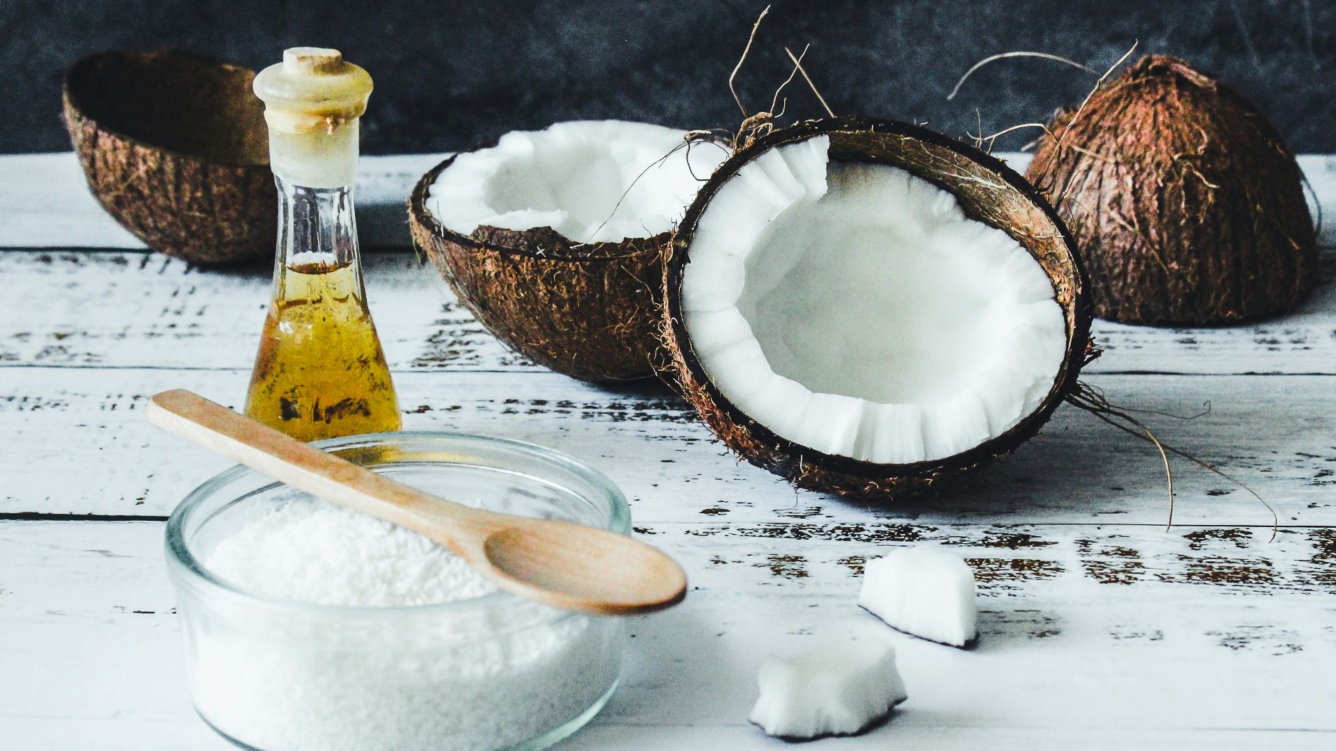 white powder in clear glass jar beside brown wooden spoon