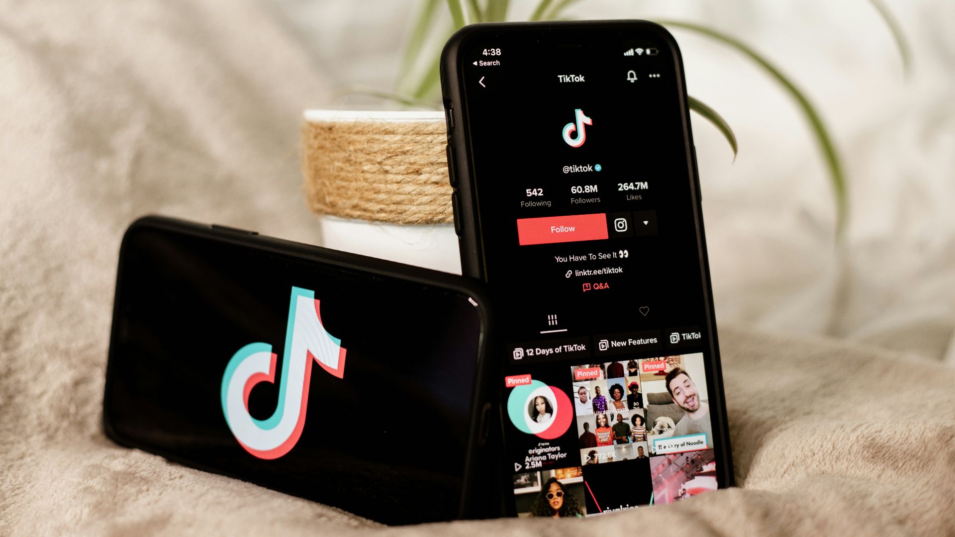 a couple of cell phones sitting on top of a bed