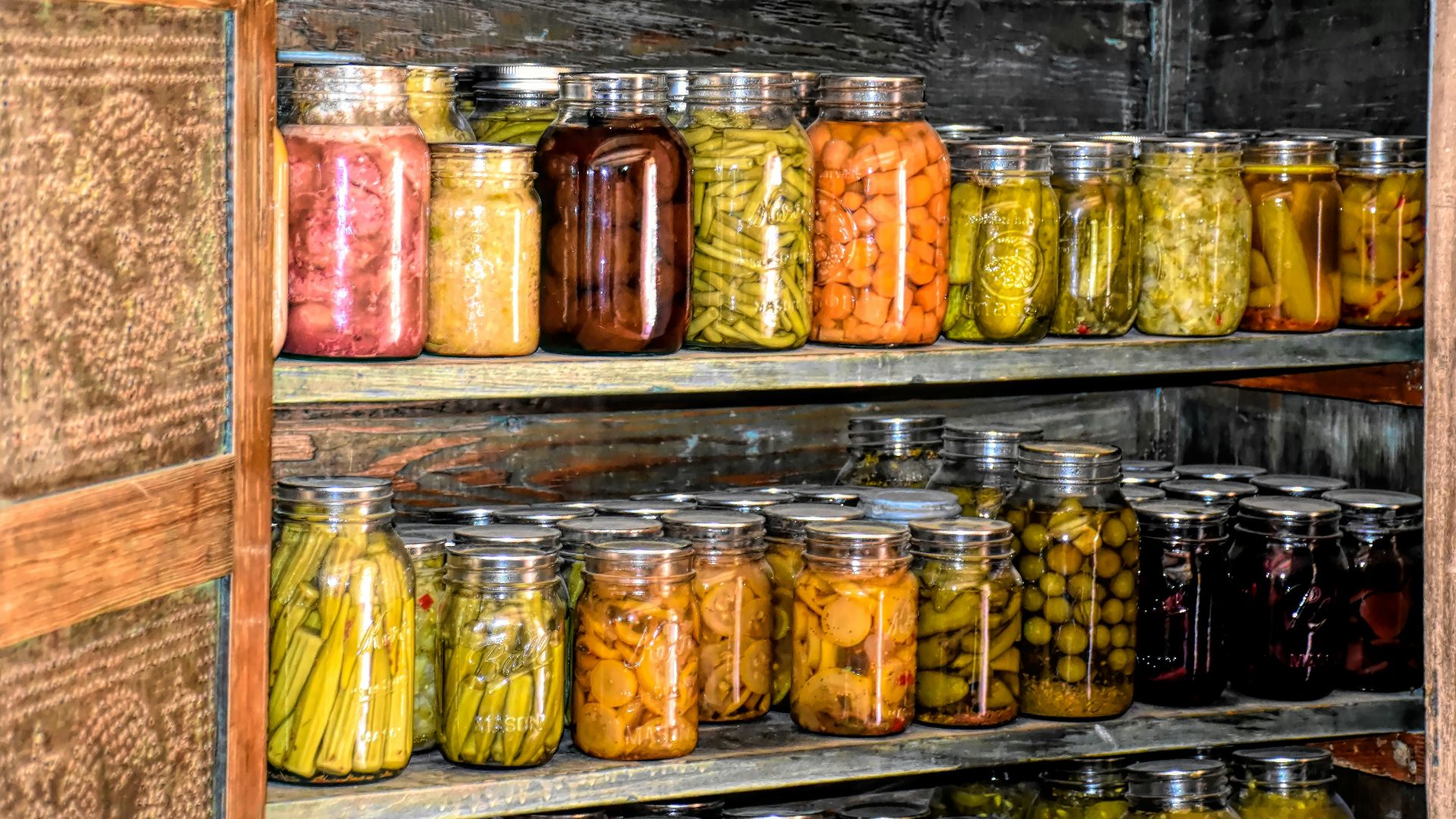 a wooden shelf filled with lots of jars of food