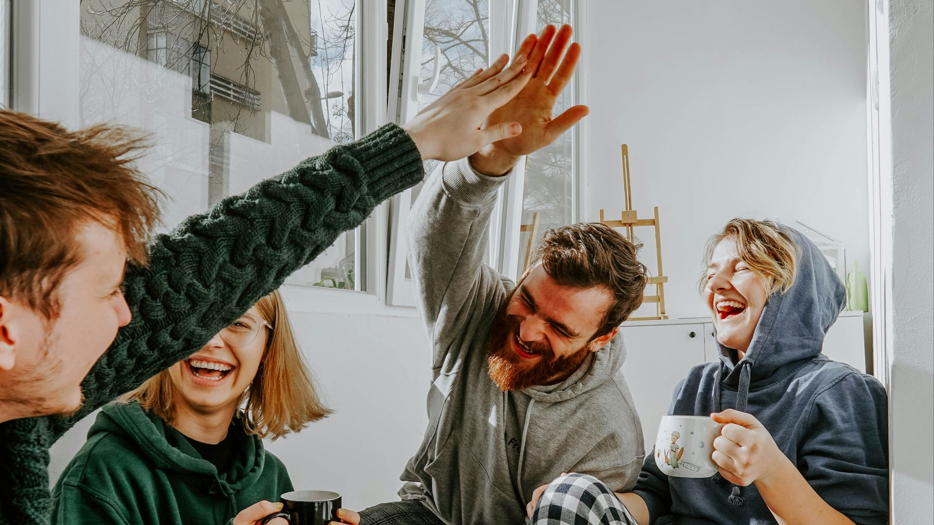 woman in black and white checkered long sleeve shirt sitting beside man in green crew neck