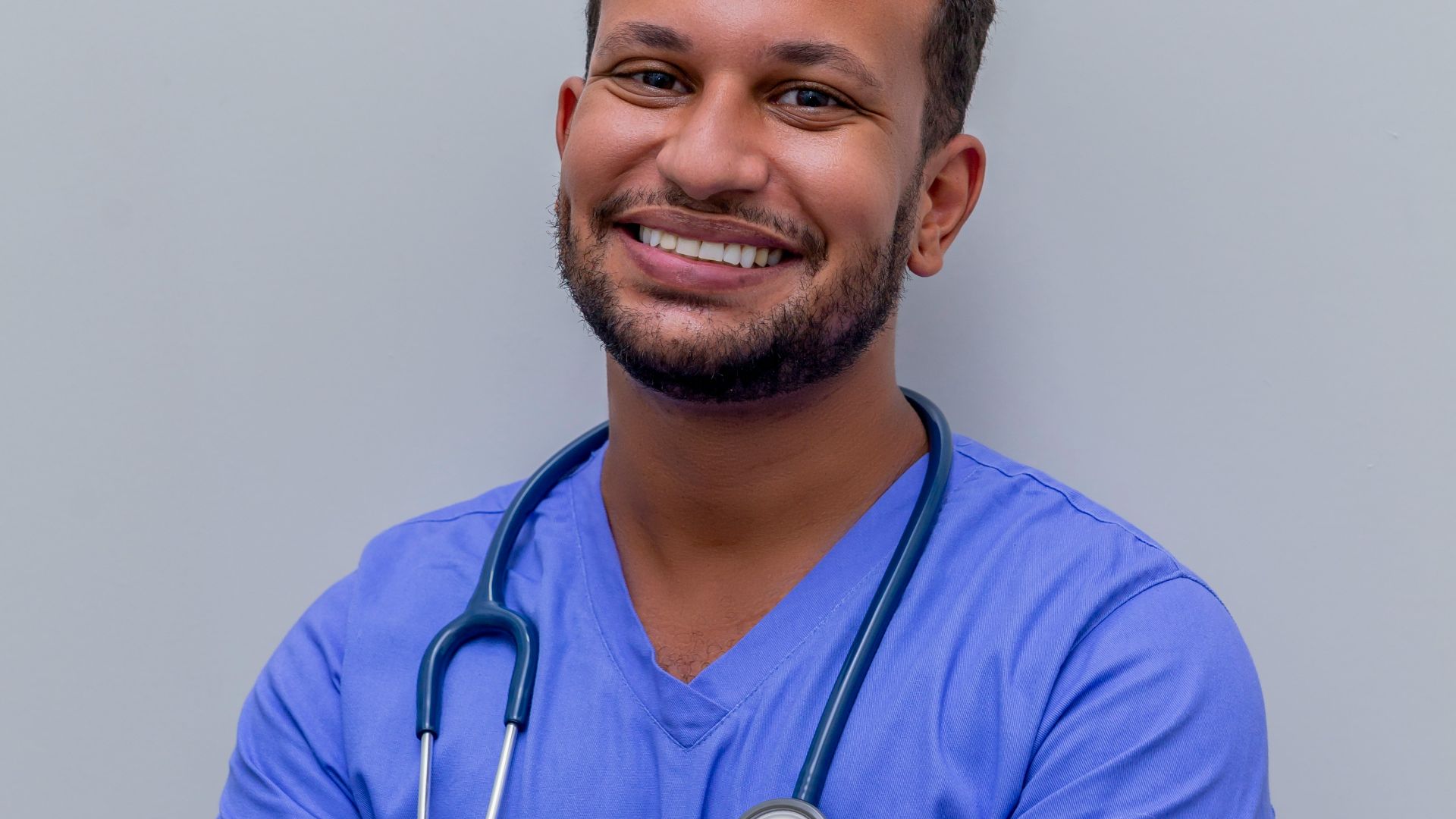 man in blue crew neck t-shirt smiling
