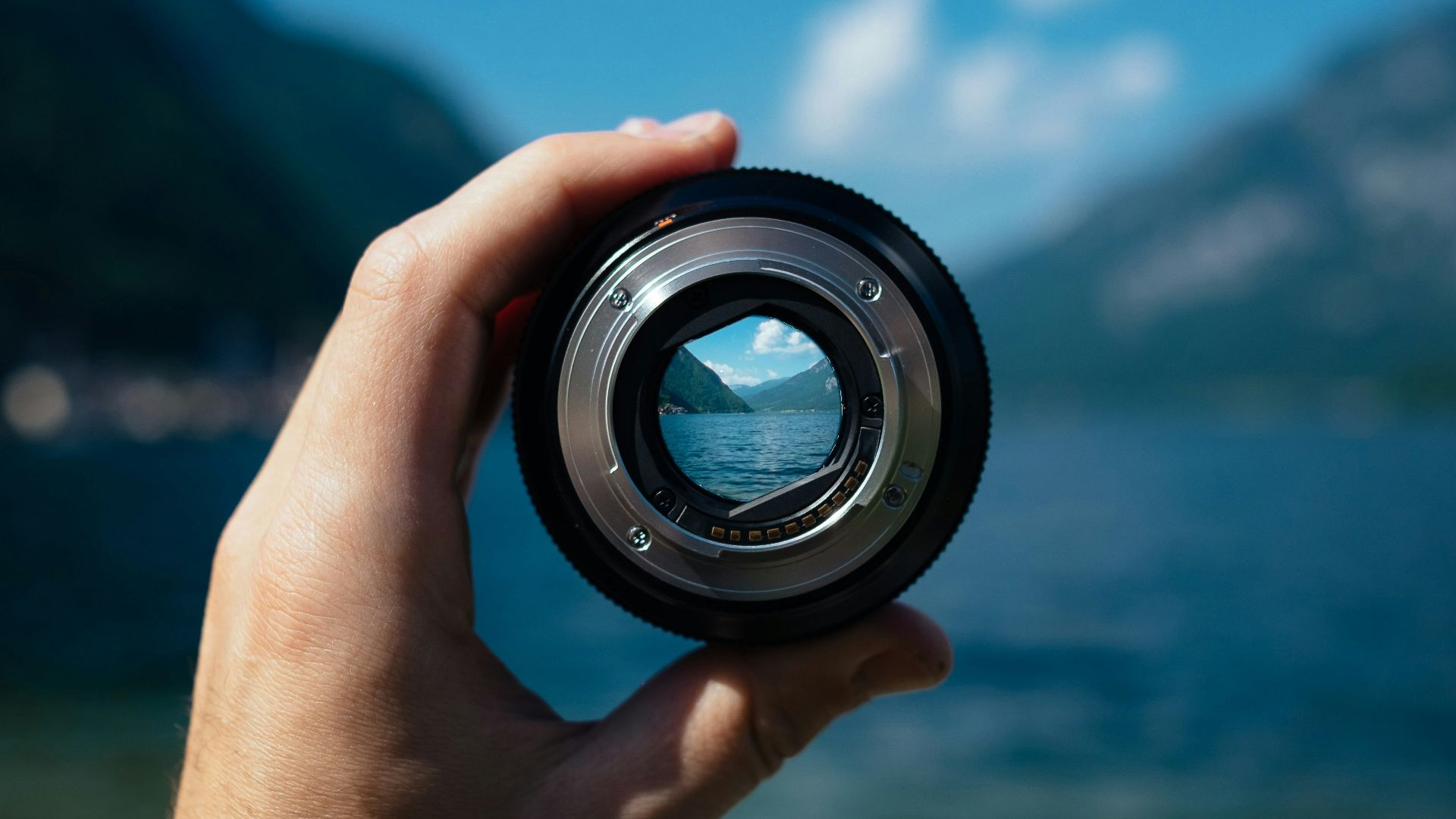 person holding camera lens