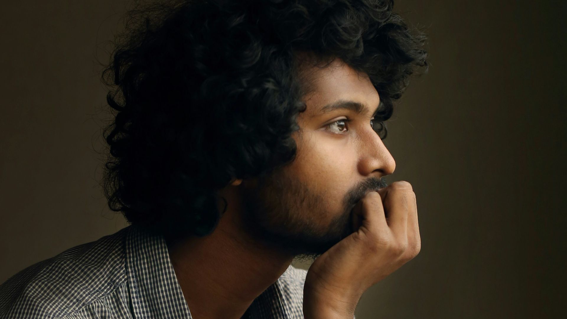 man in gray and white checkered dress shirt