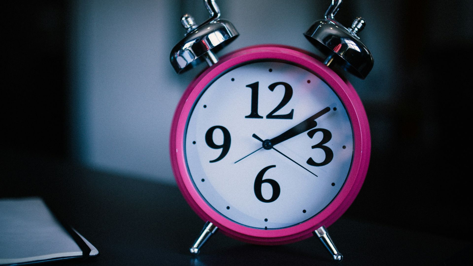 pink bell alarm clock showing 2:10