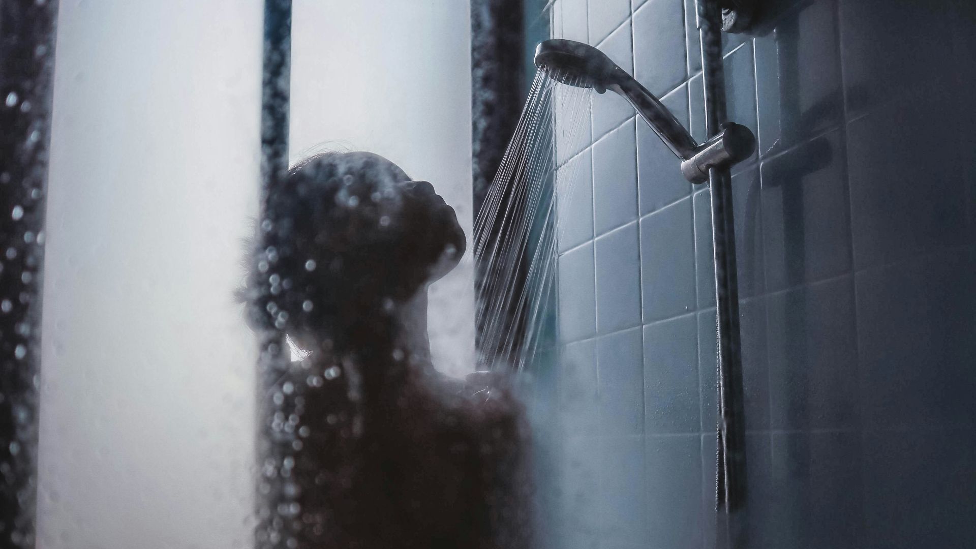 woman under showerhead