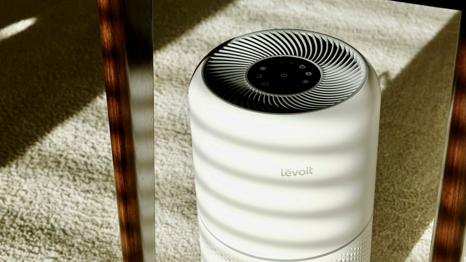 a white air conditioner sitting under a table