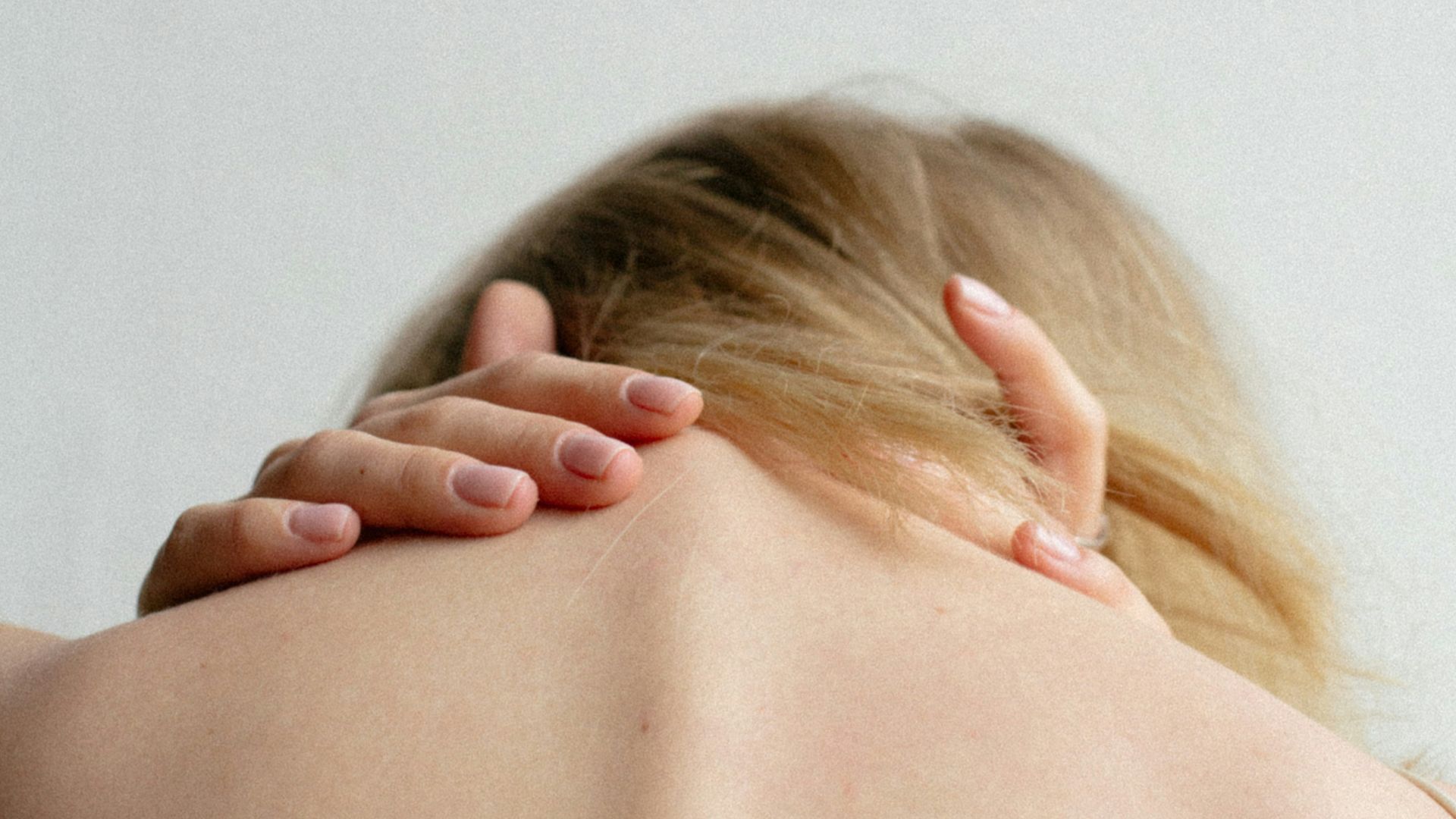 woman covering her breast with her hand