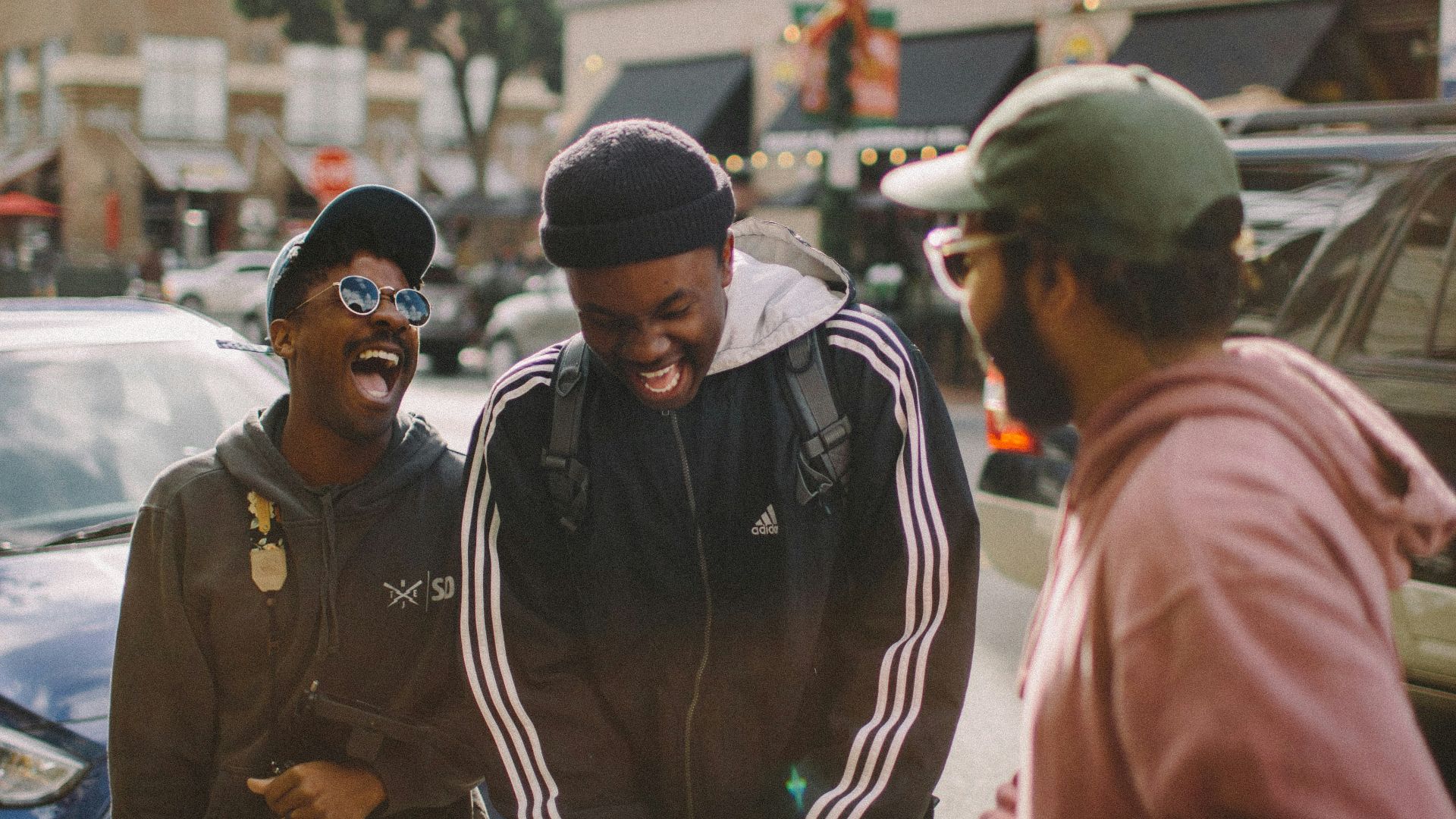 three men in jacket laughing at each other