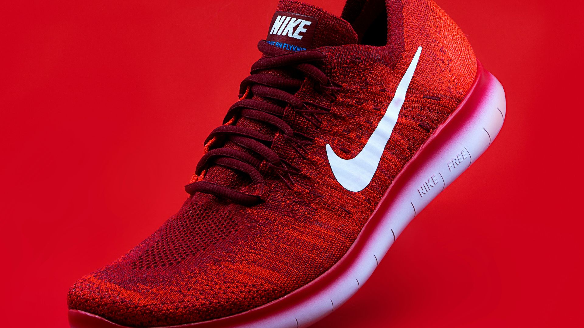 unpaired red Nike sneaker