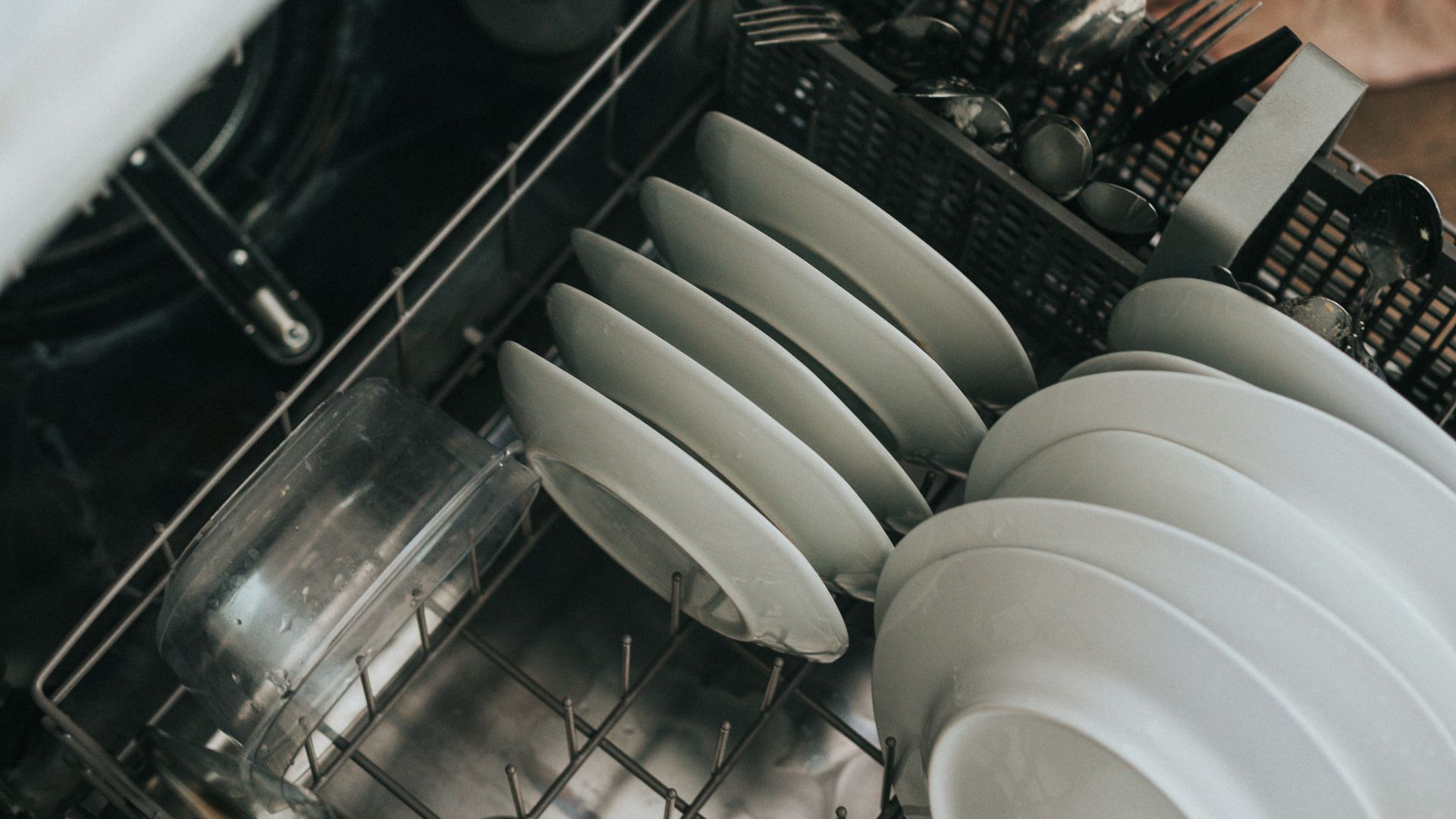 white ceramic plate on black dishwasher
