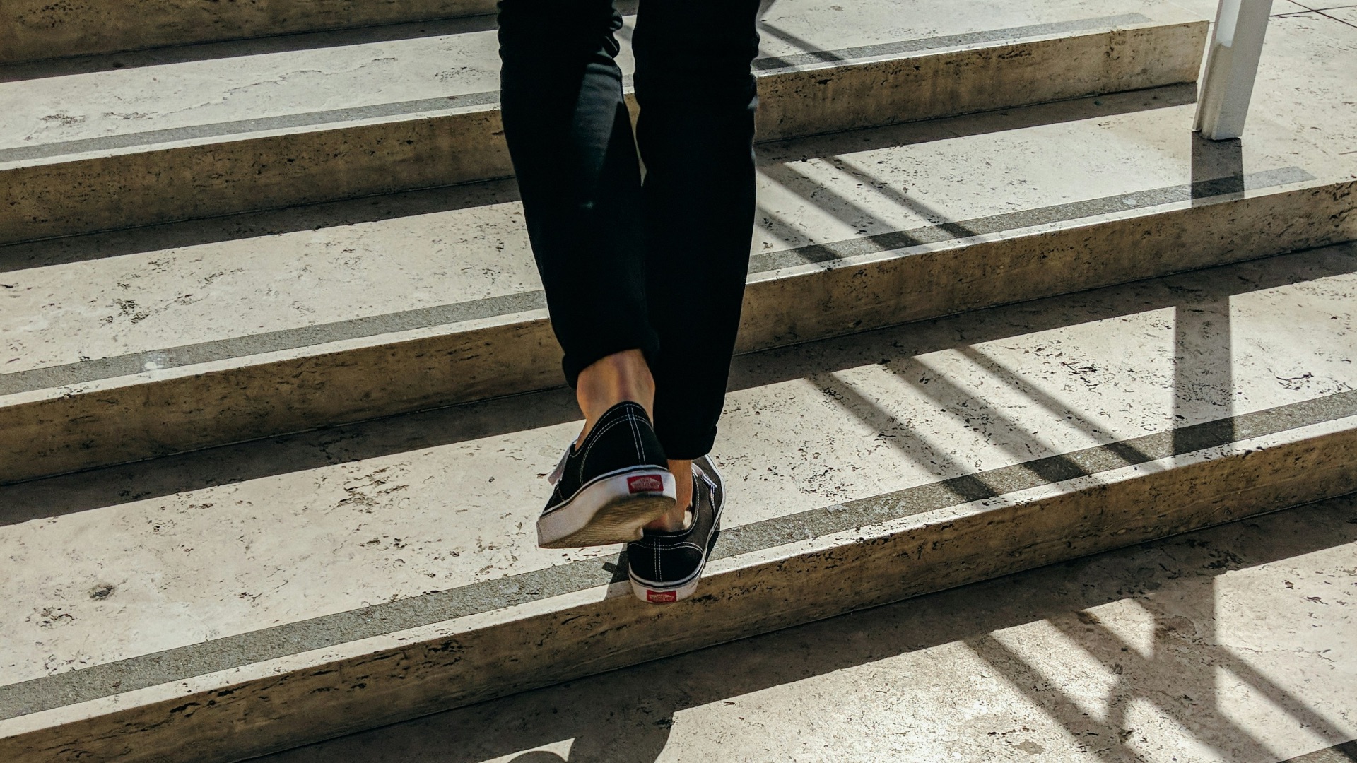 person walking on concrete stair
