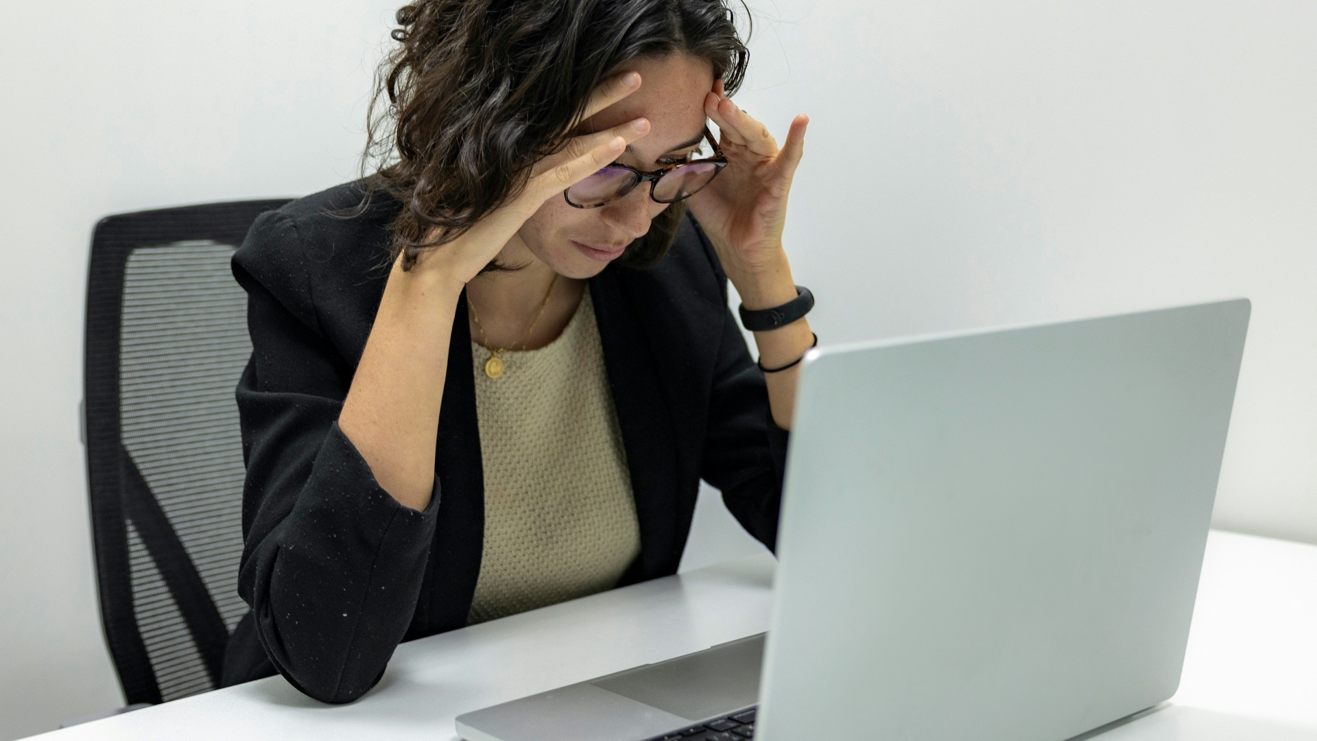 a woman sitting in front of a laptop computer
