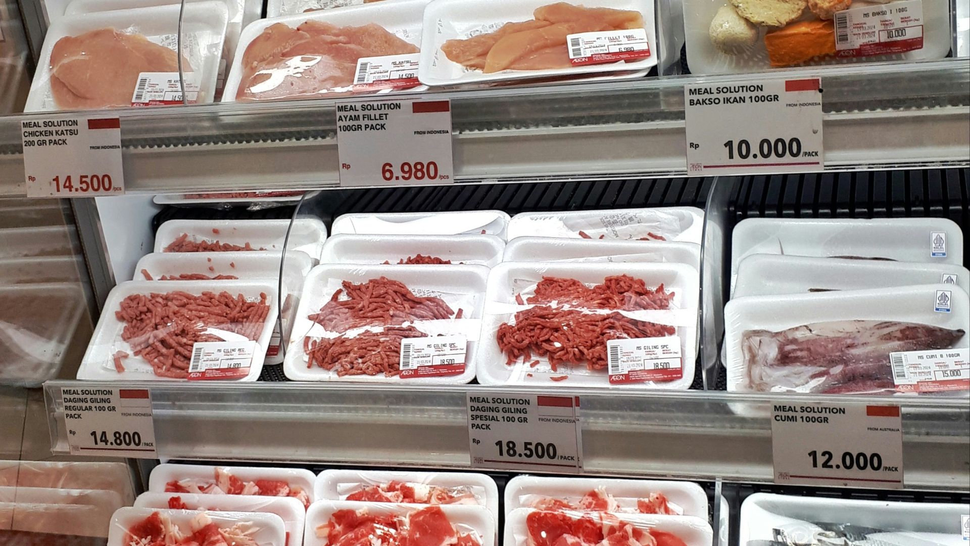 A display case filled with lots of different types of meat