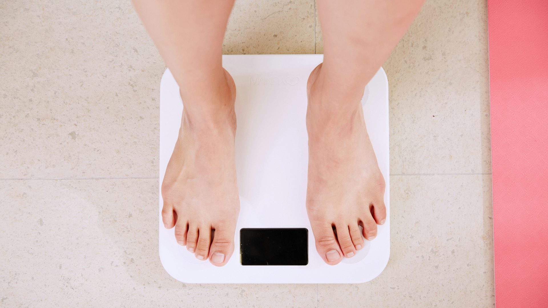 person standing on white digital bathroom scale