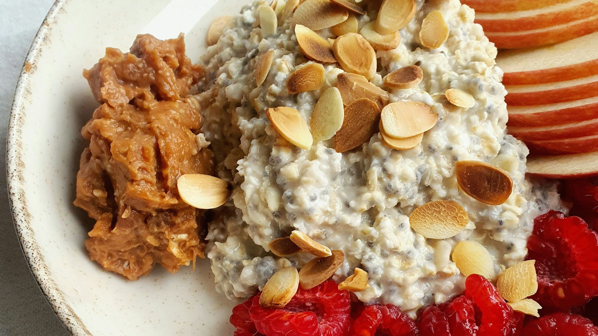 a bowl of oatmeal with fruit and nuts