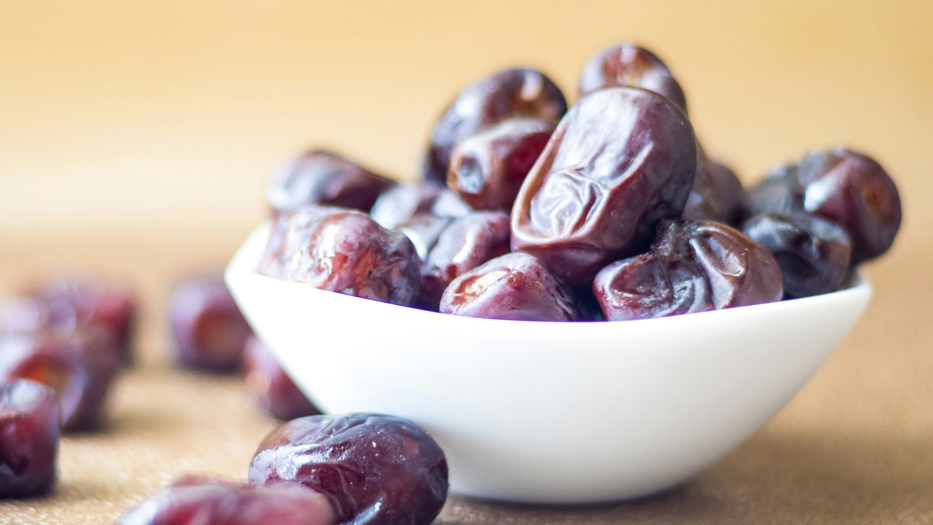 brown round fruit on white ceramic bowl