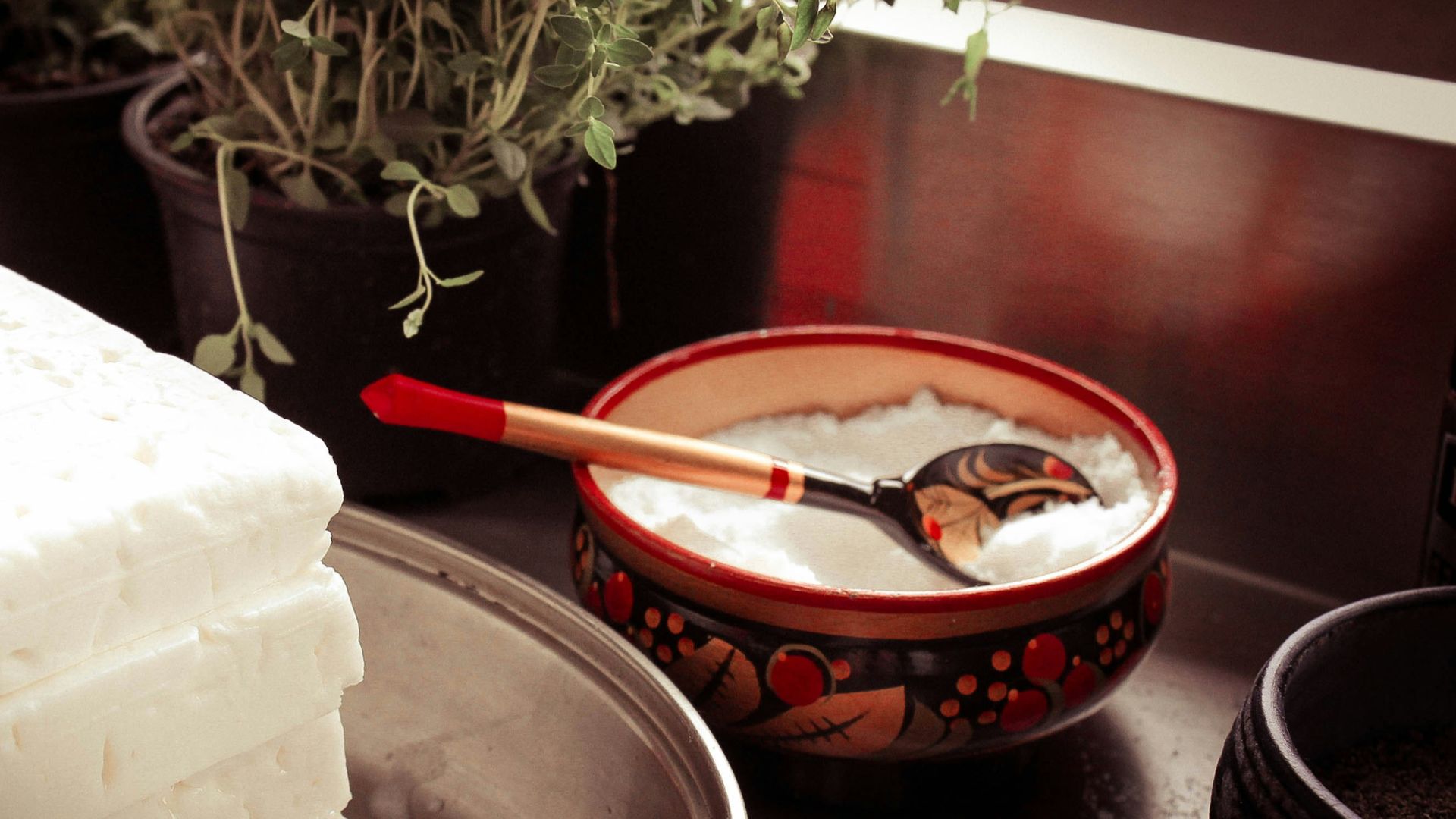 red ceramic bowl on gray spoon