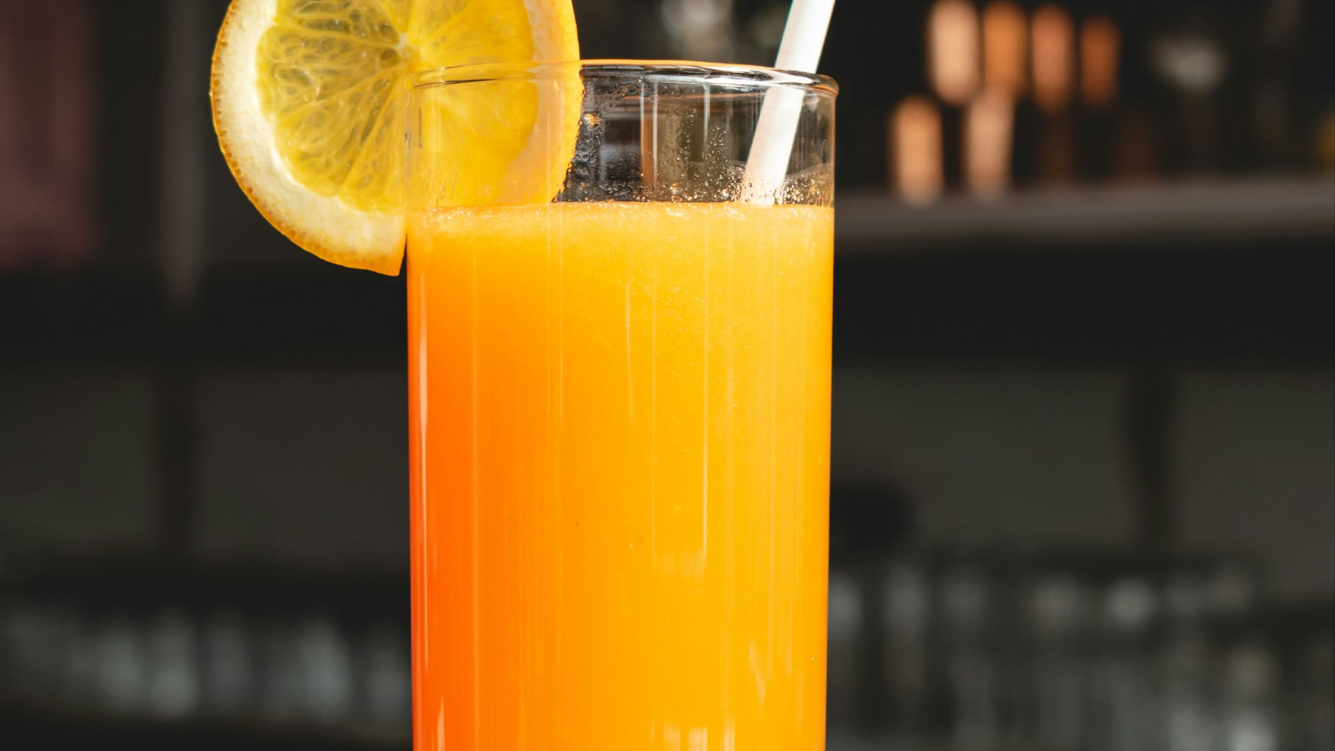 orange juice in clear drinking glass