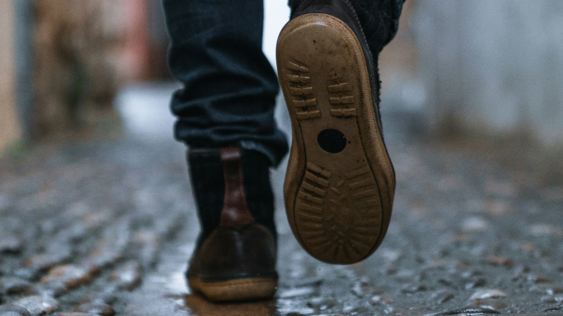 close-up photography of person walking on pavement