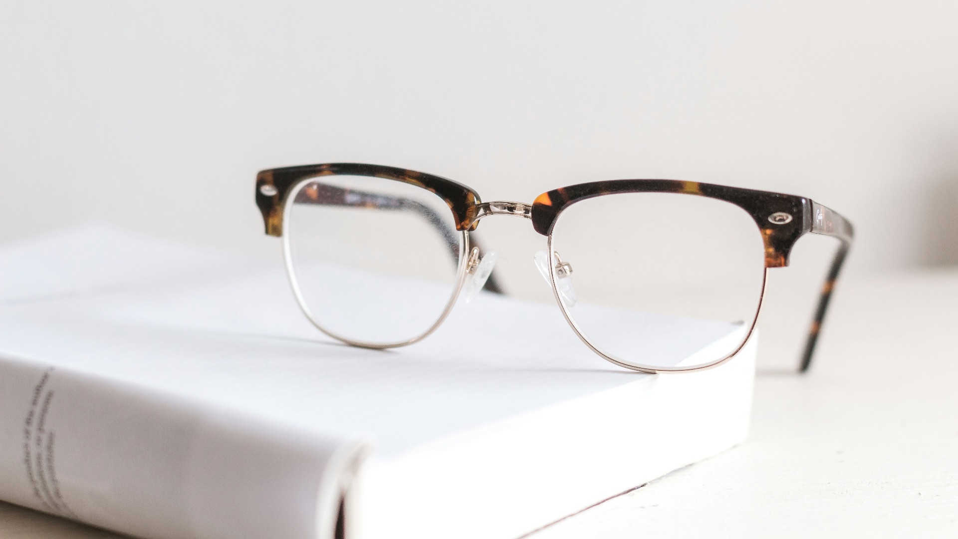 clear eyeglasses on book