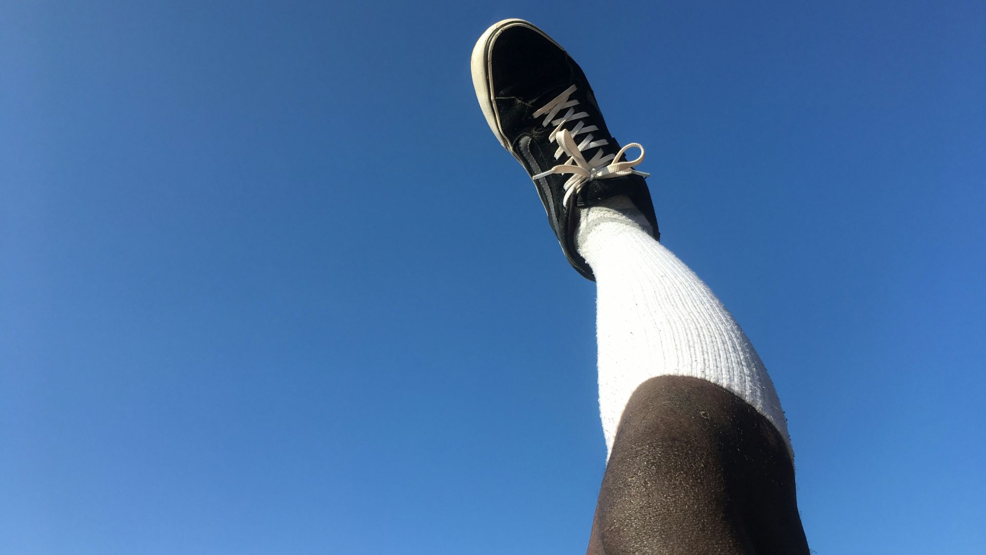a person's leg with a shoe on it