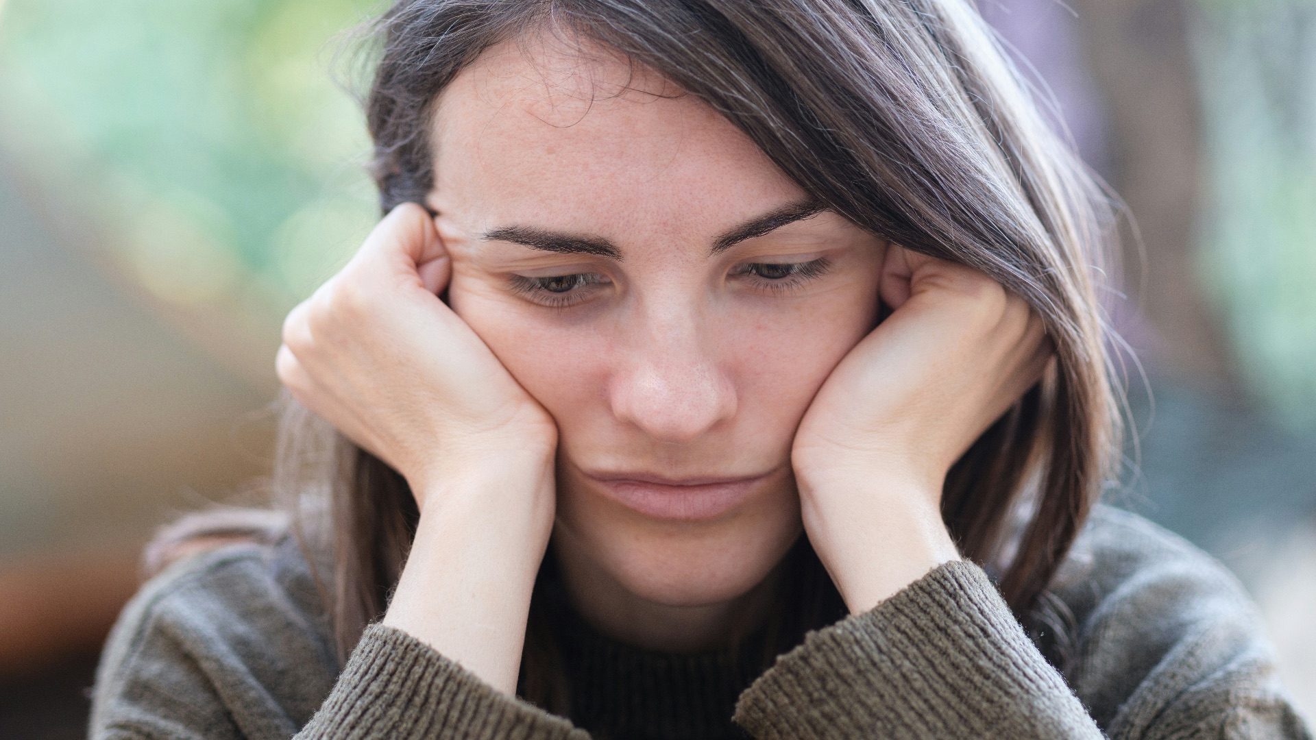 a woman holding her head in her hands