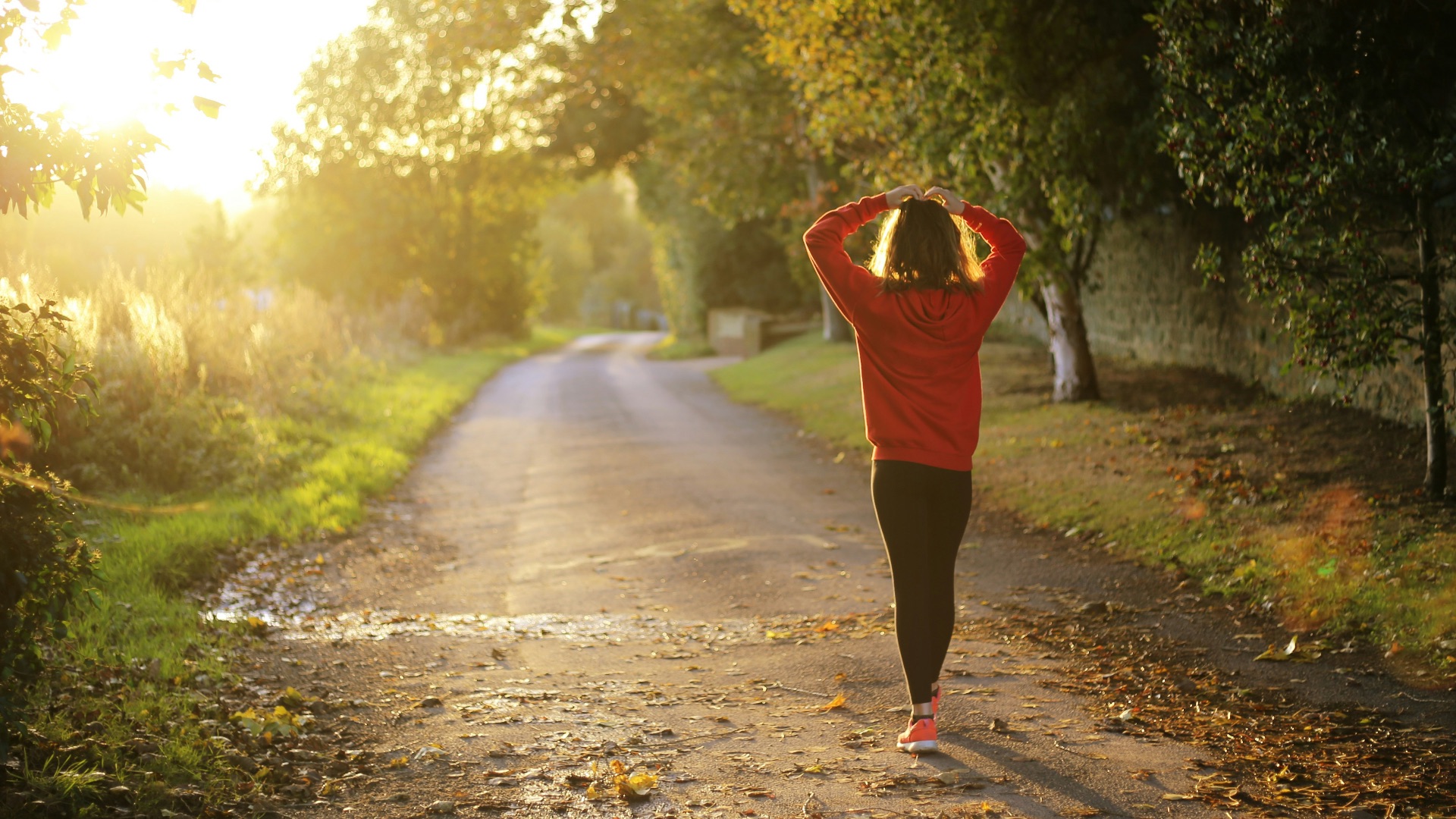 woman walking on pathway during daytime