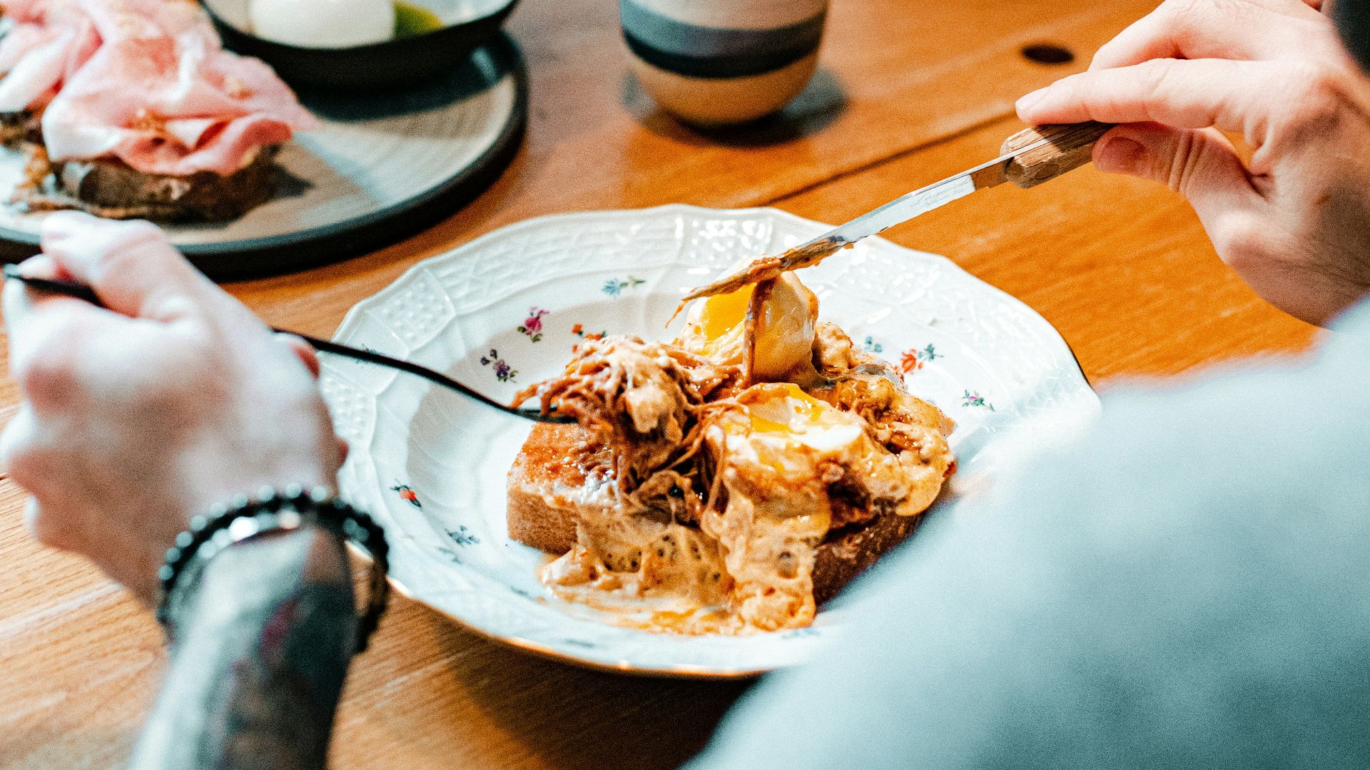 a man sitting at a table with a plate of food