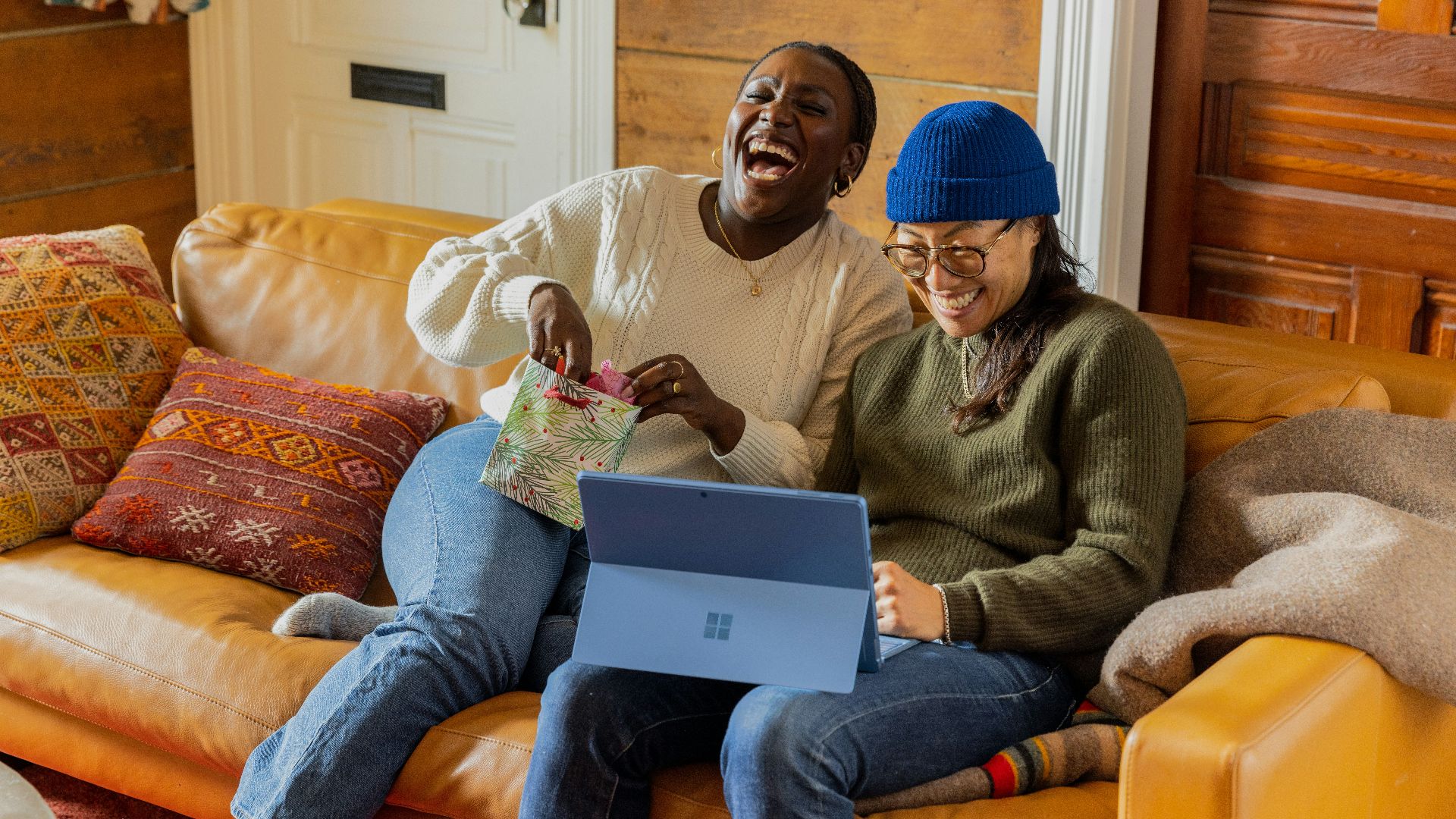 a person sitting on a couch with a laptop