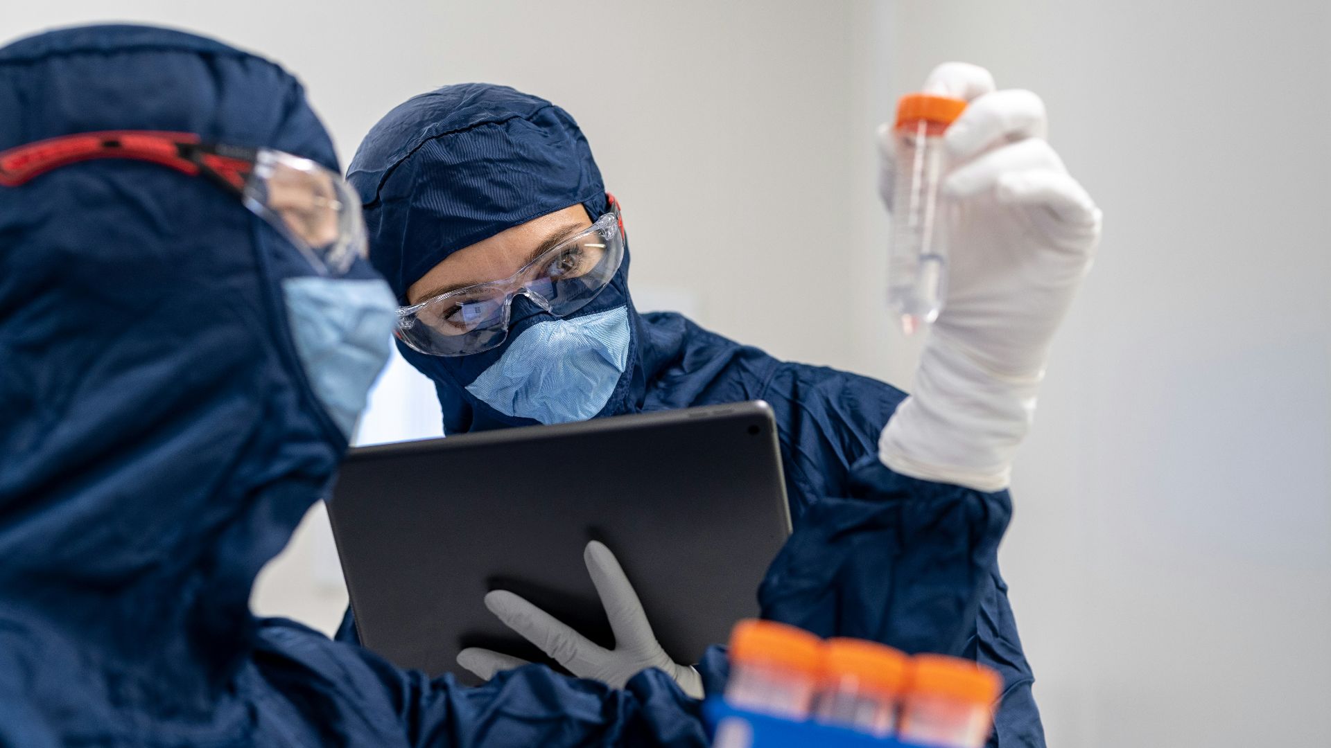 a person in a mask using a laptop