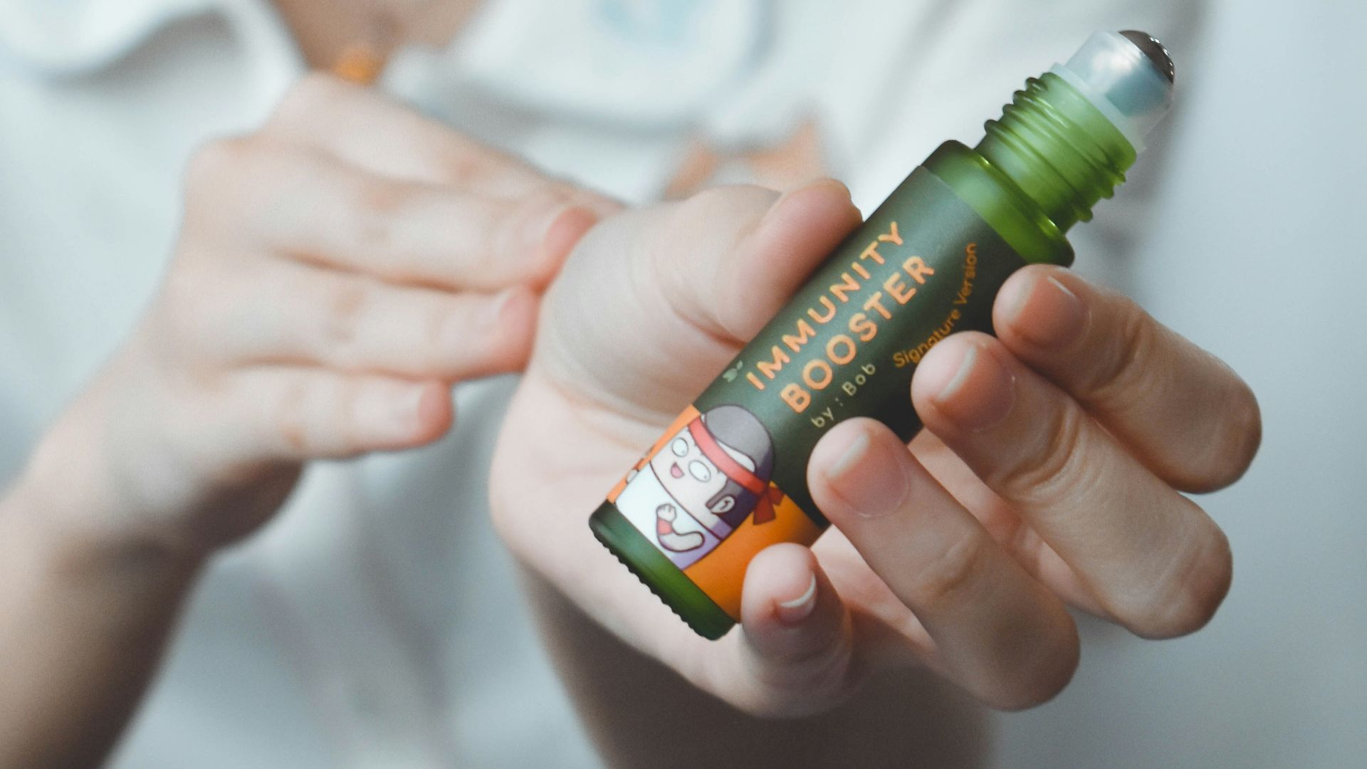 woman holding green and white labeled bottle