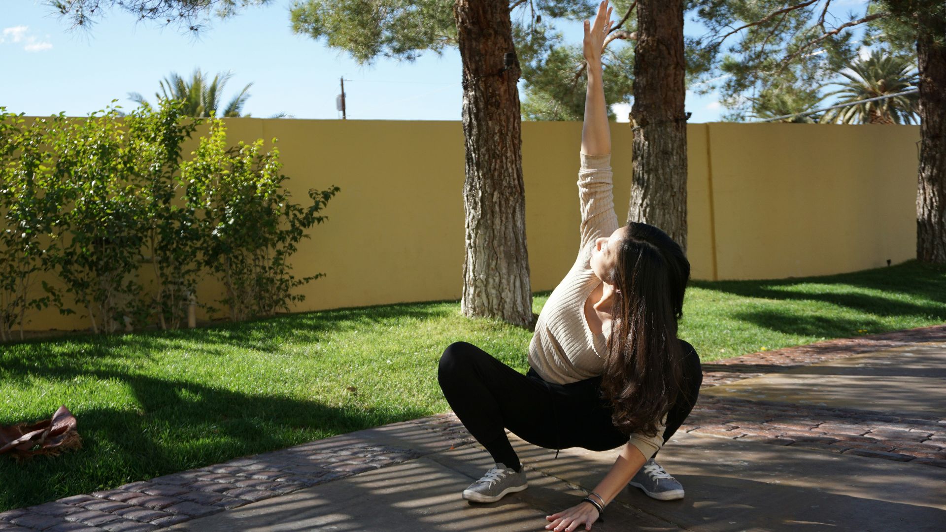 a woman doing a handstand in a yard