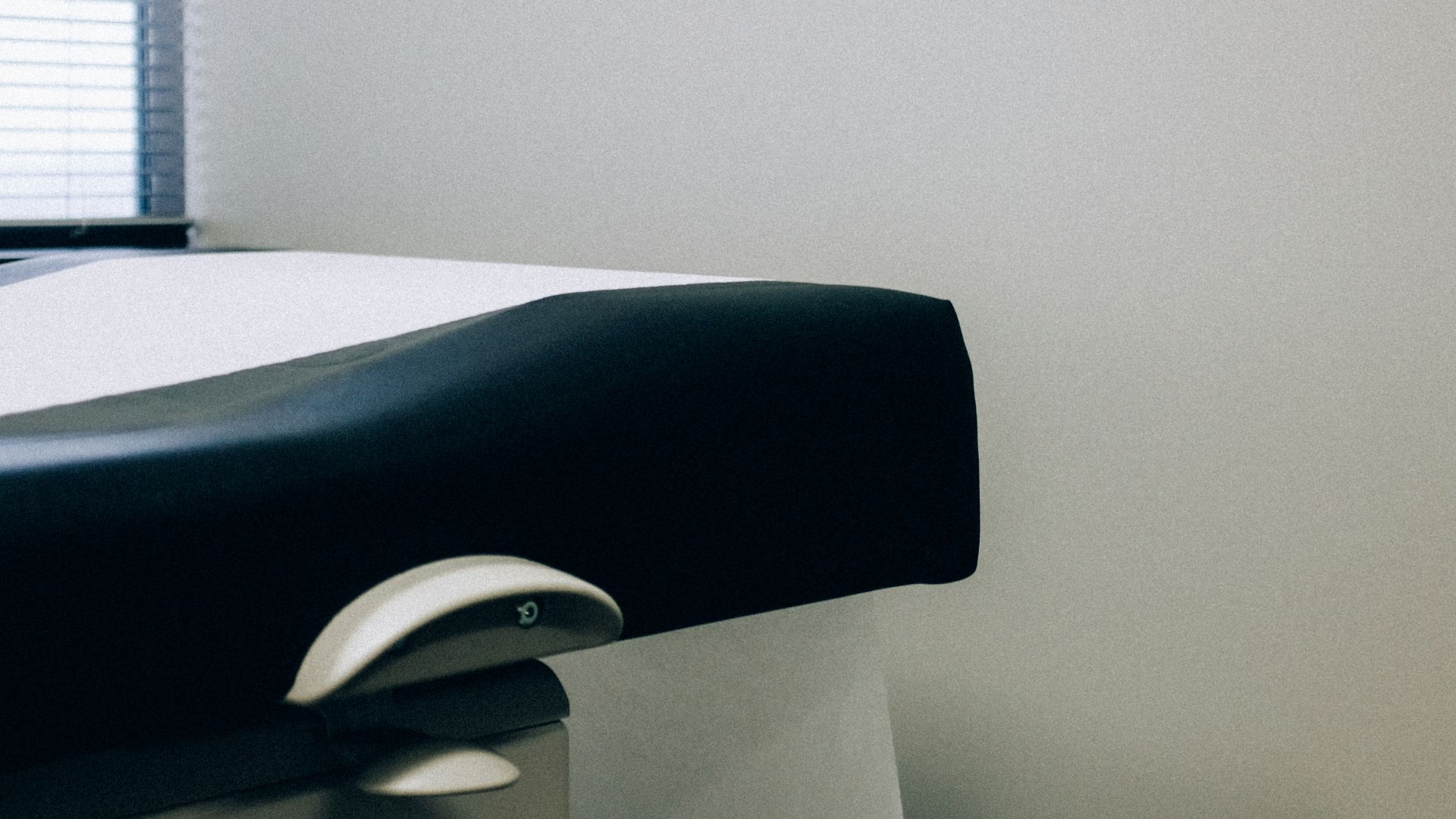 a black and white photo of a hospital bed