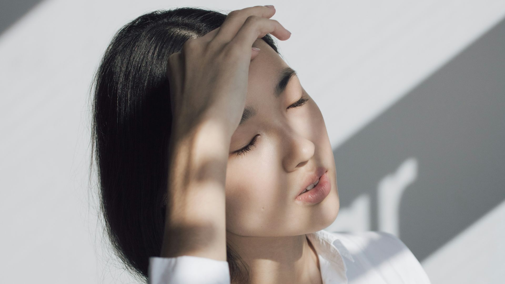 woman leaning on white table