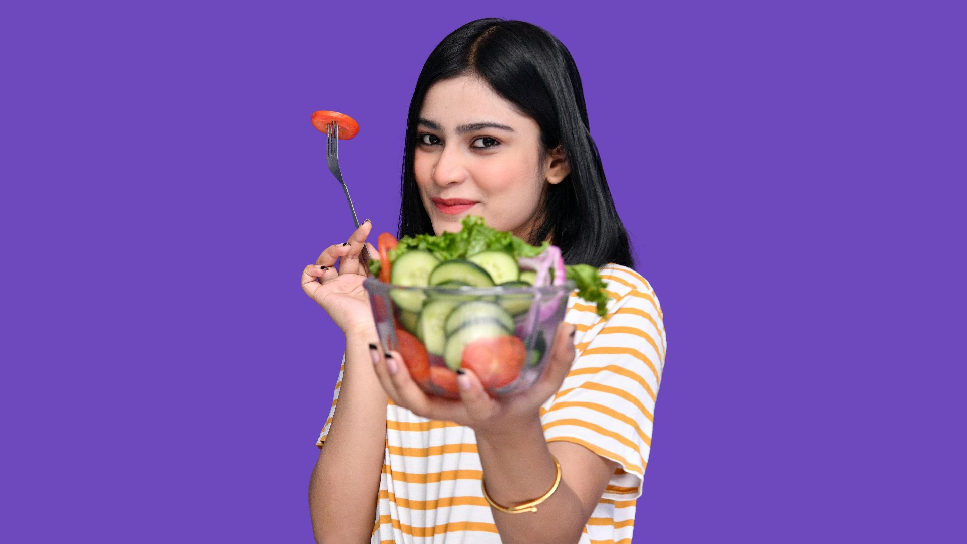 a woman holding a bowl of fruit