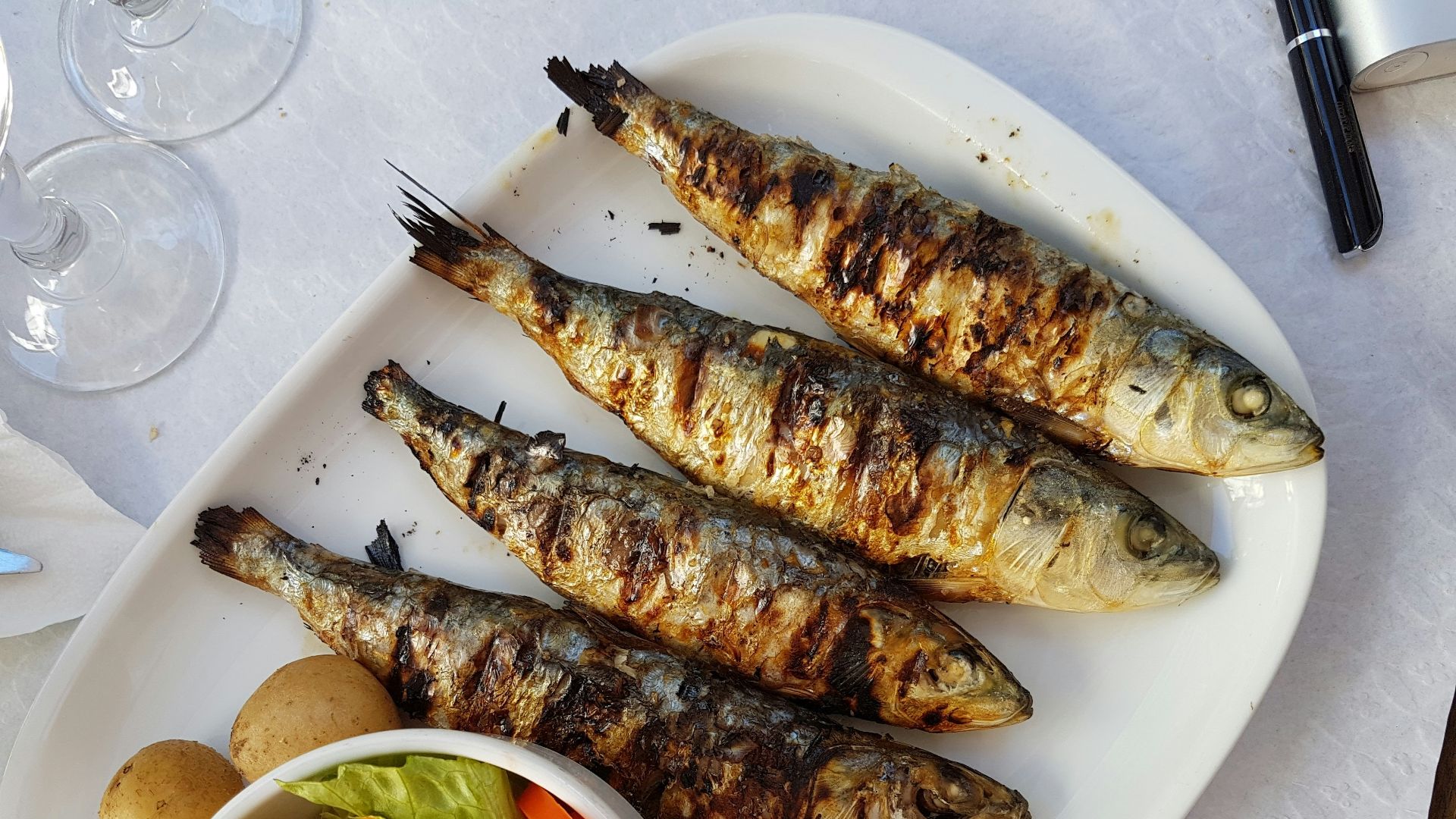 grilled fish with vegetable salad on white ceramic plate