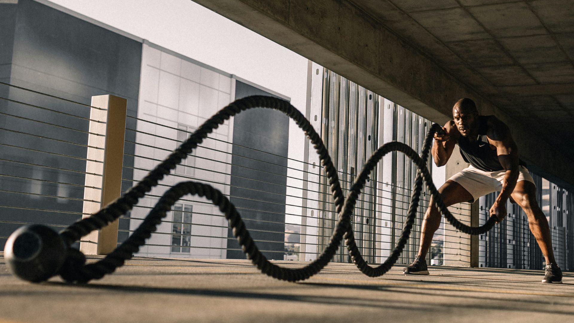 woman in black tank top sitting on brown wooden bench